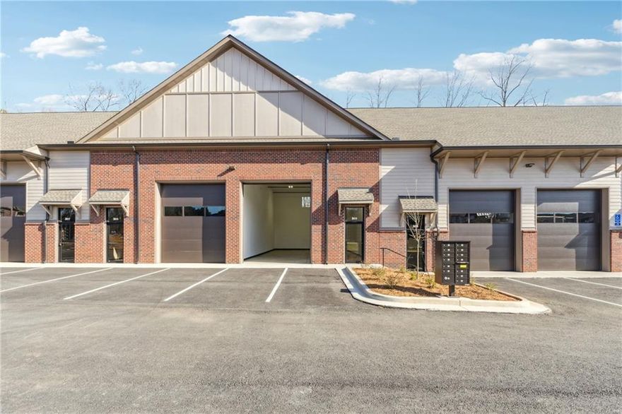Welcome to your perfect industrial workspace in the heart of Forsyth County! This newly constructed, small-bay warehouse condo offers the ideal solution for light industrial, personal, or hobby use. Featuring 20-foot ceilings, an oversized 12' x 14' insulated overhead door, and fully insulated walls and ceilings, this space is built for functionality and flexibility. The unit includes central HVAC, an ADA-compliant half bath with a tankless water heater, and high bay LED lighting. Thoughtful touches like drywall finishes, a laundry sink, interior hose bib, and 110v outlets on both ends enhance usability. Enjoy the convenience of 2 assigned parking spaces plus shared overflow, all within a professionally managed condominium community with protective covenants. Located just minutes from GA-400, this property offers quick access to both Alpharetta and Cumming. Whether you're expanding your business or need premium storage or shop space, this unit checks every box.