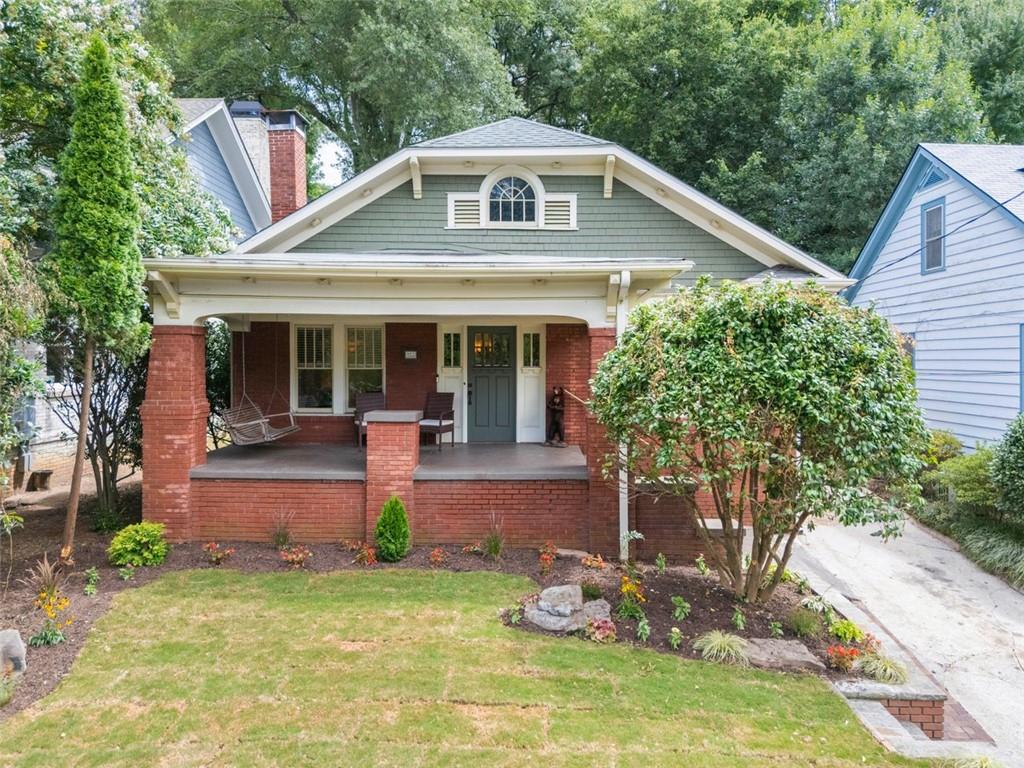 Open House: Sunday 1-3. Perched gracefully above the street, this 1920 Craftsman captures the best of intown Atlanta living with its preserved architectural details, flexible footprint, and an enviable address in one of the city’s most walkable neighborhoods. The deep, professionally landscaped lot with alley access offers future potential for a garage, carriage house, or ADU, all within steps of vibrant neighborhood amenities.
Inside, original hardwood floors, deep moldings, and vintage doorknobs with working locks create a timeless feel. The spacious living and dining rooms lead to a thoughtfully designed chef’s kitchen complete with stone countertops, Wolf double convection ovens with gas cooktop, Dacor warming drawer, beverage cooler, deep pastry prep counter, and abundant storage within custom, high-end, furniture-quality cabinetry.
A screened porch with a tongue-and-groove pitched ceiling connects to one side of the stone patio and flows directly into one of the bedrooms, creating a seamless indoor-outdoor retreat. The other side of the patio extends from the breakfast room, offering a perfect spot for dining or entertaining. Both bathrooms are fully renovated, with one featuring luxurious marble finishes and the other offering a spacious shower with dual showerheads. Modern comforts include a tankless water heater and an immaculate, fully encapsulated crawlspace with storage.
The large attic with soaring ceilings offers easy expansion potential, allowing you to grow without sacrificing yard space. The covered front porch invites quiet moments, while the elevated lot provides privacy and curb appeal.
Historic Poncey-Highland is an extremely desirable neighborhood full of craftsman bungalows, quaint condos, and thriving local retail, restaurants, and grocery stores in every direction. Freedom Farmer’s Market is a beloved Saturday ritual, and Freedom Park offers a community garden, playground, and miles of walking and biking trails. Adjacent neighborhoods such as Virginia-Highland, Inman Park, Little Five Points, Old Fourth Ward, and Candler Park are all within easy reach. Top-rated schools like Springdale Park Elementary, The Suzuki School, Druid Hills Child Development Center, and Atlanta Montessori International School in Druid Hills are nearby, completing the ideal intown lifestyle.