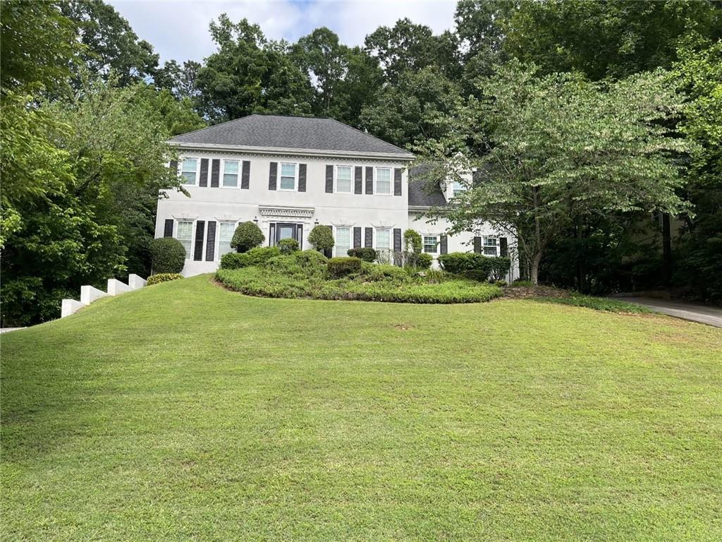 Beautiful European Home in the quiet sought-after Belgrave Square Subdivision. This stunning 3-sided stucco home features 5 bedrooms with 4 1/2 bathrooms and a full finished basement. Crown Molding and Hardwood Floors throughout the entire main and upper floors. From the welcoming foyer, enjoy a seamless flow to the living room, formal dining room, den with a cozy fireplace and wet bar, sunlit sunroom overlooking the backyard, and a renovated kitchen with stainless steel appliances, double oven, island, granite countertops, wine fridge, eat-n breakfast room and a desk. The main level also includes a guest bedroom and full bath. Rear stairs in the kitchen. The upper level hosts a spacious loft area, master bedroom/bath, laundry closet and two guest rooms. Master bath has two vanities, separate jacuzzi tub and shower and a cedar walk-in closet. The lower basement level is fully finished with a living area with fireplace, exercise room, full kitchen, 1 full and 1 half bath. Ready to be the perfect in-law suite. Get ready to entertain your guests in the huge backyard with a full kitchen, fire pit and stone patio. 2-car garage. HOA only $25 annually. A fantastic school district and minutes from downtown, shopping and major highways. Come and see it before it's gone!