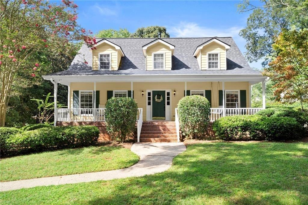 Charming Cape Cod in Coveted Roswell—Just 1 Mile (and a Delightful Golf Cart Ride) from Historic Canton Street! Welcome to this beautifully maintained Cape Cod-style home, ideally located in one of Roswell’s most desirable areas. Just minutes from the heart of historic downtown, this home offers timeless charm paired with thoughtful modern updates. Step onto the inviting front porch—complete with rocking chairs and a porch swing — and into a warm, welcoming interior featuring gleaming hardwood floors throughout the main level, as well as the stairs, upstairs landing and hallway. The oversized kitchen is perfect for entertaining, showcasing granite countertops, stainless steel appliances, and a cozy fireplace that adds character and comfort. Enjoy seamless indoor-outdoor living with a spacious deck overlooking a fenced backyard—ideal for relaxing, grilling, or hosting guests. Inside, you'll find three working fireplaces located in the family room, kitchen, and expansive primary suite, creating a cozy ambiance throughout. The primary bedroom features a walk-in closet and a recently renovated private bathroom, complete with a tiled shower and double vanity—offering comfort, style, and convenience right off the bedroom. Additional highlights include a finished basement room—perfect for a gym, office, or media space—and a dedicated workshop in the extra-large two (2) car garage. Recent upgrades include a brand-new roof, two (2) new HVAC systems, fresh interior paint, a newer water heater, and updated lighting throughout. Situated on a level lot in a quiet, friendly neighborhood close to awesome restaurants and breweries, award-winning parks, top-rated schools, and shopping, this home also boasts detailed molding, generous closet space, and ample storage throughout. Too many features to list—come see this Roswell gem for yourself!