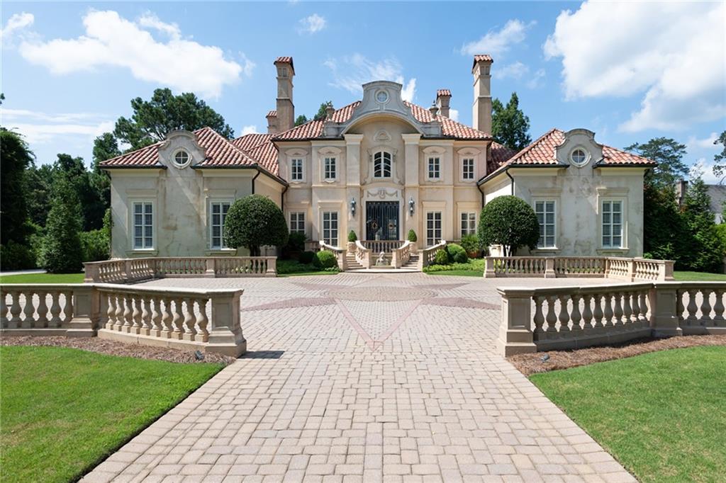 This home is so much more than just another mansion - It is simply a masterpiece showcasing exquisite curb appeal, exceptional architecture, highest attention to detail and 1.4 acres perfectly located just outside Buckhead’s Tuxedo Park, in sought after Sandy Springs. This Italianate Villa begins with an expansive gated entry leading to a large front yard and courtyard. Custom front doors, made in France and imported from an estate in South America, welcome you into a two-story light filled foyer with marble floors and a dramatic wrought iron staircase leading to the upper level. The main level features a library with herringbone floor, 12+ seating dining room, family room with two story coffered ceiling open to the kitchen/breakfast area and 2 story living room with French doors open to the pool. Additionally the incredible owners suite is on the main and features marble floors, sitting area, private doors to the pool and a fabulous closet including cedar. The bath continues with 24 carat fixtures, steam shower, soaking tub, bidet and a dressing/vanity room. Upper level features 3 private guest suites. The terrace level features interior and exterior access, family room, billiard room, gym, full bath, theatre, and in-law suite with kitchen, living room, dining area, bedroom and full bathroom. Enjoy seven custom fireplaces including the library, dining room, family room, living room, owners suite, terrace level living room and in-law suite. The superior quality continues outside with a stone patio, pool/spa and a pool house with full kitchen, living room and full bath. Additionally a private guest apartment features a bedroom (not incl. in main bed count), living room, full kitchen, full bath. This home has recently had many fabulous updates throughout which show beautifully in the photography.