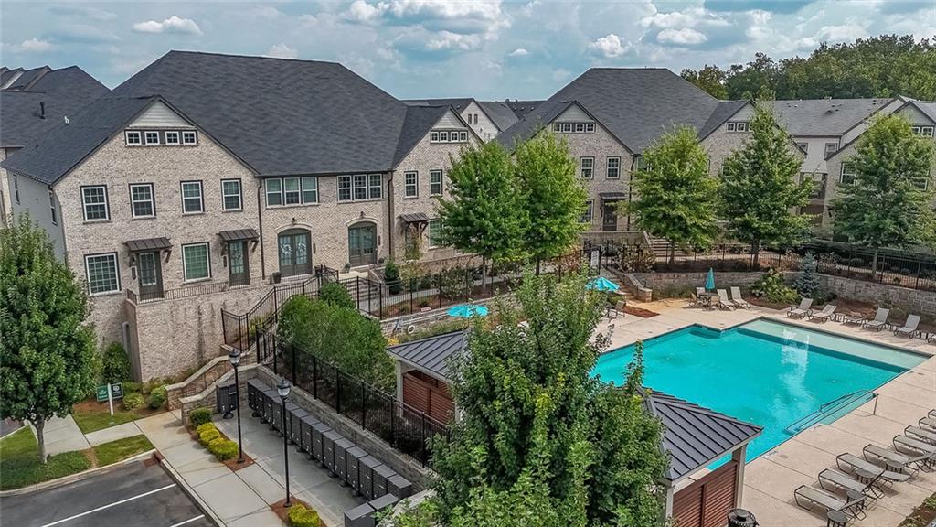 || END UNIT TOWNHOME || || BUILT 2021 – LIKE NEW || || RESORT-STYLE AMENITIES || || LUXURY DESIGN CHOICES || || CUSTOM STORAGE THROUGHOUT || || GARAGE WIRED FOR EV || || OWNER’S SUITE WITH SPA BATH || || WOOD FLOORS THROUGHOUT 2ND FLOOR ||
** What You’ll See **
Step into a BRIGHT, MODERN home filled with thoughtful upgrades and designer touches. From the WATERFALL COUNTERTOP and FLOOR-TO-CEILING KITCHEN BACKSPLASH to the CUSTOM WOODWORK and BUILT-IN STORAGE throughout, every detail creates a polished, high-end look. Large windows bring in natural light, while carefully chosen LIGHT FIXTURES and dimmers set the perfect mood for any occasion. The OWNER’S SUITE feels like a personal retreat with an UPGRADED SPA BATH and a CUSTOM WALK-IN CLOSET.
** What You’ll Hear **
Enjoy the QUIET of an END UNIT while ceiling fans hum softly in every room. Entertaining is effortless—whether it’s laughter echoing from the OPEN-CONCEPT living area or the sounds of conversation flowing out to the BACK PORCH. In the evenings, step outside and let the gentle soundtrack of community life fade into the background as you relax by the RESORT-STYLE POOL.
** What You’ll Feel **
Experience the comfort of MODERN LIVING at its finest—WOOD FLOORS underfoot, sleek finishes in every bath, and the ease of SMART HOME features like GOOGLE THERMOSTATS. The spacious layout gives you room to spread out, while the CUSTOM STORAGE and cleverly designed MURPHY BED offer function without sacrificing style. Every space was designed to feel elevated, easy, and truly livable.
** What You’ll Experience **
This community offers a RESORT-CLASS LIFESTYLE with AMENITIES that set it apart—swimming, lounging, and connecting with neighbors in spaces designed for leisure. With EVERYDAY CONVENIENCES just minutes away—restaurants, shopping, and entertainment all within a 10-minute drive—you’ll have the freedom to live the way you want. From hosting guests in the LUXURY CHEF’S KITCHEN to enjoying private time in your spa-like suite, this home makes daily life an experience to look forward to. HOA dues are paid monthly at $285.