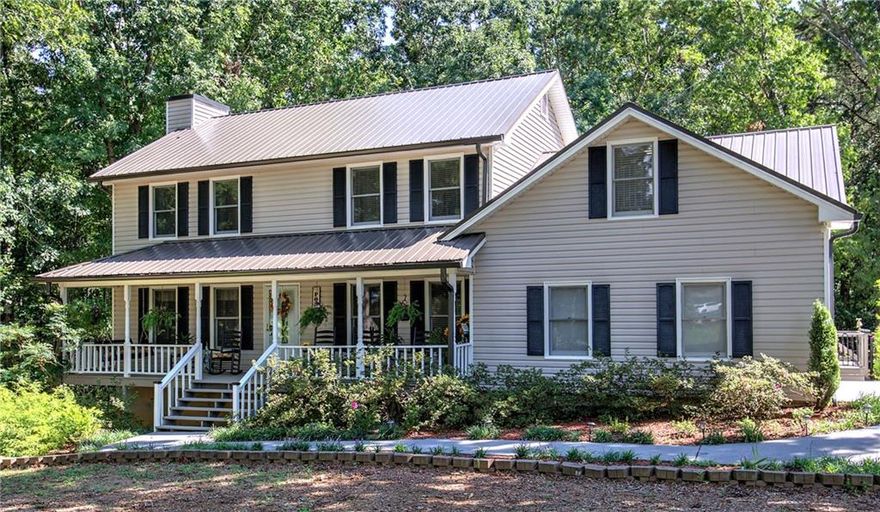 Charming Two-Story Traditional Home on 2 Private Acres!  Enjoy your morning coffee on the front porch swing of this welcoming two-story traditional home, perfectly nestled on a mostly level, wooded 2-acre lot offering peace and privacy. With inviting charm and numerous upgrades, this home is move-in ready and waiting for its new owner.  Step into a warm and spacious living room featuring gleaming hardwood floors, a cozy fireplace with ventless gas logs, and built-in cabinetry on both sides. Hardwood floors continue into the elegant formal dining room—ideal for hosting family and friends. A bright sunroom at the back of the home opens to a large deck overlooking a serene, private backyard—perfect for outdoor dining or relaxing by the raised fire pit in the evenings. 
The kitchen and breakfast area offer ceramic tile flooring, solid surface countertops, and ample space for everyday living. From the main-level double garage, enter through a convenient back foyer that connects to the kitchen and a large laundry room complete with a nearly new utility sink. Upstairs, the spacious master suite features a walk-in closet, a recently updated double vanity with granite countertop, and a luxurious walk-in ceramic tile shower. Two additional bedrooms share a full bath, also upgraded with a new granite vanity. A versatile bonus room over the garage can serve as a fourth bedroom, office, or playroom. The walk-out finished basement includes a game room, exercise room and a half bath—perfect for entertaining or creating your own retreat space. 
A separate 30' x 40' detached garage adds valuable storage or workshop space.  An adjoining 2-acre lot located to the rear of the main property is also available for purchase, offering potential for expansion or added privacy.  Don’t miss your chance to own this beautifully maintained home with room to grow—schedule your showing today!