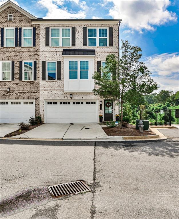 Welcome to this exquisite historic Marietta Square townhouse, a stunning blend of modern luxury and timeless charm. With 3 bedrooms, 3.5 bathrooms, and three levels of spacious living, this newer construction gem built in 2020 offers the perfect combination of comfort and style. As you step inside you'll be greeted by a fireside family room that invites relaxation and warmth. The open concept design seamlessly connects to a pristine white kitchen featuring a beautiful marble island and high end appliances, makes it a culinary enthusiast's dream. Entertain guests in the elegant 12+ person dining room, a perfect setting for memorable gatherings and celebrations. Enjoy the best of indoor-outdoor living with a screen in porch, providing a tranquil oasis for morning coffee or evening cocktails. Conveniently located near Glover Park, Lewis Park, Sessions Stand and Kennestone Hospital this townhouse offers both historic charm and modern amenities