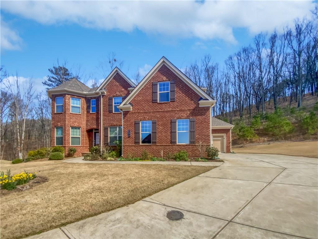 Gorgeous Brick Beauty in Sought-After Gated Community!
2470 Bridle Bridge Trail, Cumming, GA | Martingale at Mountain Crest Welcome to this stunning three-sides brick home nestled on a quiet cul-de-sac lot in the highly desirable Martingale at Mountain Crest, a prestigious gated community zoned for the award-winning Forsyth Central High School District. From the moment you step inside, you're greeted by a soaring two-story foyer and elegant formal dining room with chair rail accents. The main level features a guest bedroom perfect for in-laws or visiting guests.
The heart of the home is the bright and open Great Room, complete with two- story windows, a cozy fireplace, and custom built-in cabinetry. The adjacent gourmet kitchen offers stained cabinets, stone countertops, stainless steel appliances, a center island, a walk-in pantry, and a sunlit breakfast area overlooking the living space.
Step outside to the private deck—perfect for morning coffee or evening gatherings—offering peaceful views of the professionally landscaped backyard retreat.
Upstairs, the spacious master suite features a tray ceiling, luxurious en-suite bath with dual vanities, soaking tub, separate shower, and a generous walk-in closet. Three additional bedrooms and two full baths provide ample space for family or guests. Convenient upstairs laundry room makes everyday living a breeze.
The full daylight basement is ready to finish, offering endless possibilities— home theater, gym, extra living space—you name it! Walk out to the covered patio and enjoy the lush garden and blooming landscaping.
Community Amenities Include:
Olympic-sized pool + kiddie pool with waterslide and mushroom waterfall 8 lighted tennis courts + pickleball courts
Fitness center, Community Park & playground
Move-in ready and brimming with features, this home truly has it all. Don’t miss your chance to live in one of Cumming’s premier communities—schedule your showing today!