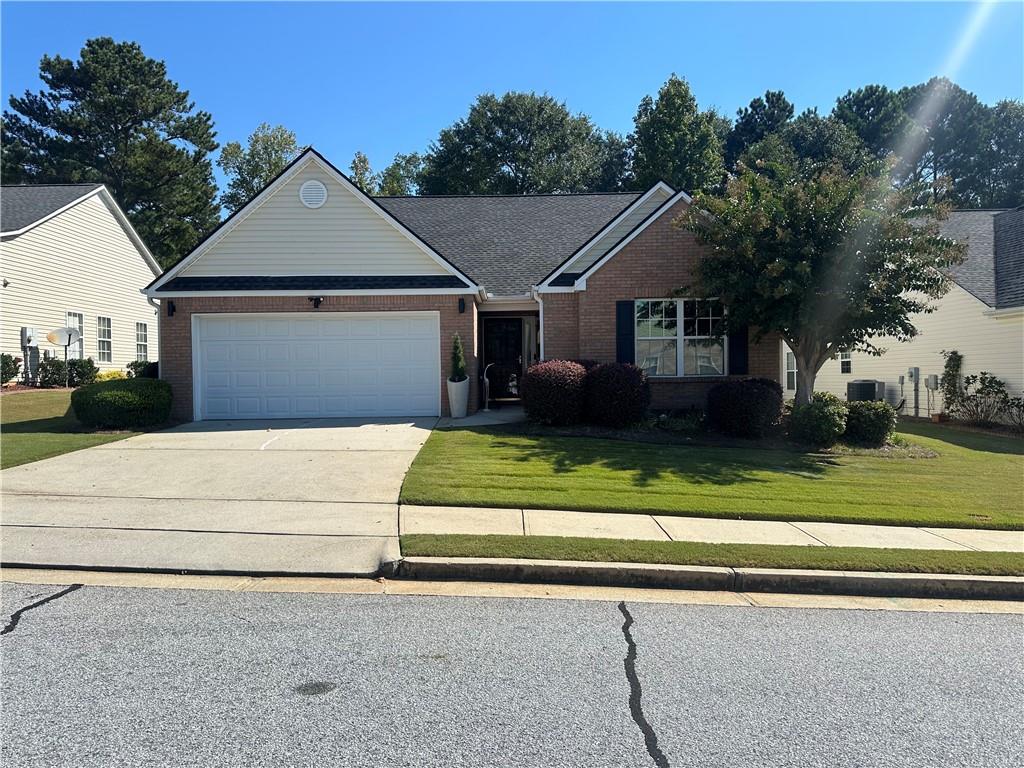 Welcome to this beautifully updated 3 bedroom, 2 bath brick front ranch located in a vibrant 55+ swim and pickleball community. Offering one of the largest floor plans in the neighborhood, this home has been thoughtfully renovated from top to bottom and is truly move-in ready. Step inside to find all new luxury vinyl plank flooring with no carpet anywhere. The vaulted great room features a cozy corner fireplace and opens to a bright sunroom/flex space, perfect for a home office or relaxation area. The renovated kitchen showcases stunning new quartzite countertops with waterfall edges and a walk-in pantry, while the adjacent laundry room provides easy access to the garage. The spacious owner's suite includes a tray ceiling, a renovated bath with modern finishes, large walk-in shower, and generous closet space. Two additional bedrooms and a fully updated hall bath are tucked away on the opposite side of the home for privacy. Designed for stepless living, this home combines comfort with convenience. Freshly painted throughout, every detail has been refreshed to create a light and welcoming feel. Enjoy a low-maintenance lifestyle with community amenities, while being just minutes from shopping, dining, and medical facilities.