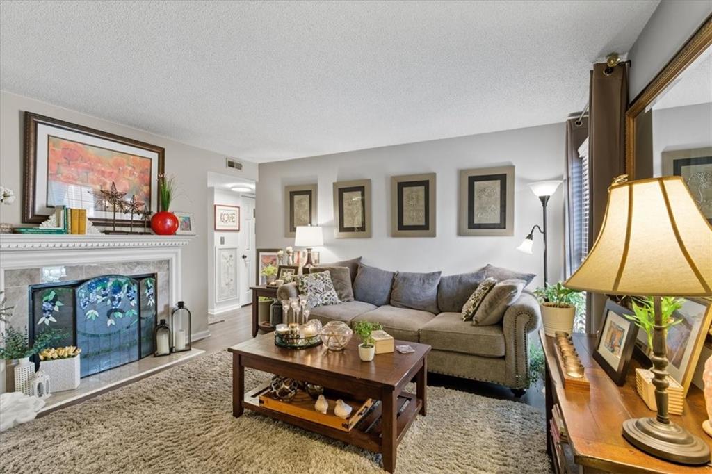 Come FALL in love with this adorable garden condo situated close to the Marietta Square. The front porch is inviting for relaxing outside. The unit features a roommate floor plan and each bedroom comes with large closets and separate private bathrooms. The living room features a beautiful fireplace and large window. There is an extra bonus room that can be used as a guest room, office, or sunroom with many windows for natural light. This unit also has a separate dining room space big enough to fit a table for 6-8 people. The door is on the main level with only a few steps, but the back of the unit is on the second floor. The neighborhood is gated and so close to the Marietta Square.