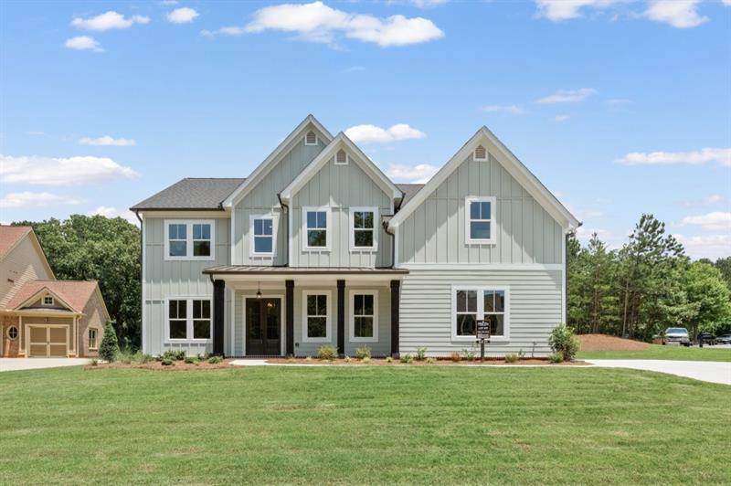 The Belville Plan built by Peachtree Residential Properties. Quick Move-In! Enjoy summer evenings on the rocking chair front porch. This brand new home has it all and offers a perfect blend of a beautiful new home and a place to enjoy the lake. All the homes in this 15 homesite community come with a deeded, covered, deep water slip located at the community dock. The lake is just a quick golf cart ride away for you to enjoy your boating adventures. The wide foyer is flanked by the Dining Room with wainscoting and a Flex Room that is perfect for an office or a place for a grand piano! The impressive 2 story Family Room has beautiful stained beams and plenty of windows. The fireplace has built-in cabinets on both sides and a wood fireplace surround. The open concept living is perfect for entertaining with a kitchen with cabinets to the ceiling, a large island, SS Kitchen Aid appliances, walk-in pantry and Breakfast Room. A bonus is the large Keeping Room with a vaulted ceiling. This home has a large Guest Room on the main floor wth a full bath, shower and a walk-in closet. Upstairs is a catwalk with hardwood floor, stained railing and metal balusters overlooking the Family Room. There is a reading nook at the upstairs hallway. The spa like Owner's bath has a shower, soaking tub and double vanities with quartz countertop as well as a walk-in closet and a smaller closet. Upstairs there are 2 secondary bedrooms with private baths. There are engineered hardwoods in the main living areas, carpet in the bedrooms and tile in the Laundry Room and Baths. This home has a 2-car side entry garage and a tandem garage. This is a beautiful level lot. This community is a perfect place to call home and is minutes away lake fun, dining and shopping!