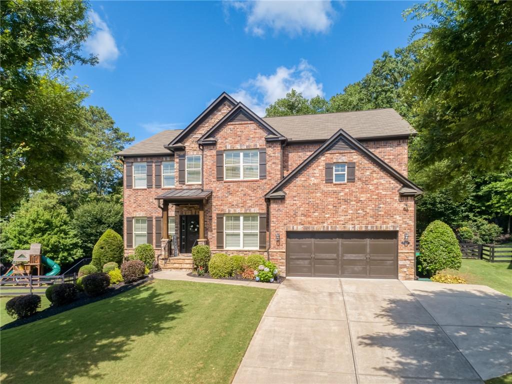 Welcome to this Upgraded and Impeccably Maintained home nestled behind the gate and tucked back in a quiet cul-de-sac, offering the perfect blend of privacy, elegance, comfort, and functionality. The finish quality here on all three levels will be hard to beat! Step inside to discover an open-concept layout filled with natural light. At the center of it all is a chef’s kitchen designed to inspire. Crisp white shaker cabinets accented with oil-rubbed bronze hardware pair beautifully with warm granite counters and a striking dark-stained island - a perfect gathering place for morning coffee or evening wine with friends. Stainless steel appliances, 5-burner gas cooktop, stainless vent hood and French-door refrigerator make entertaining a joy. A herringbone tile backsplash and pot-filler faucet add both elegance and function, while glass pendant lights cast a warm glow over the workspaces. Hardwood floors tie it all together, leading seamlessly into the open family room which boasts a cozy stone fireplace and wood accent wall, creating a warm and inviting atmosphere. There is also a Main Level Guest Room, separate Dining Room AND Study. Upstairs, the owner’s suite feels like its own private haven. A place to unwind in the sitting area or soak in the spa-inspired bathroom after a long day. Also features separate shower, dual vanities and ample closet space. Not to worry, there’s plenty of room for everyone else to retreat and recharge. The secondary bedrooms are equally spacious and offer plenty of flexibility. The finished basement is an inviting extension of the home as main-floor quality was maintained throughout. With its spacious layout, rustic barn doors, and warm tones, it’s perfect for movie nights, game tournaments, or even hosting holiday dinners in style. Outside, enjoy a private, fenced backyard that backs to trees OR ease down to the covered patio off the lower level that is perfect for watching football in the fall with a view of the cozy fire pit area. Oh, your cars will love their home too with the Guardian Garage showroom floors. This home truly has it all—inside and out!