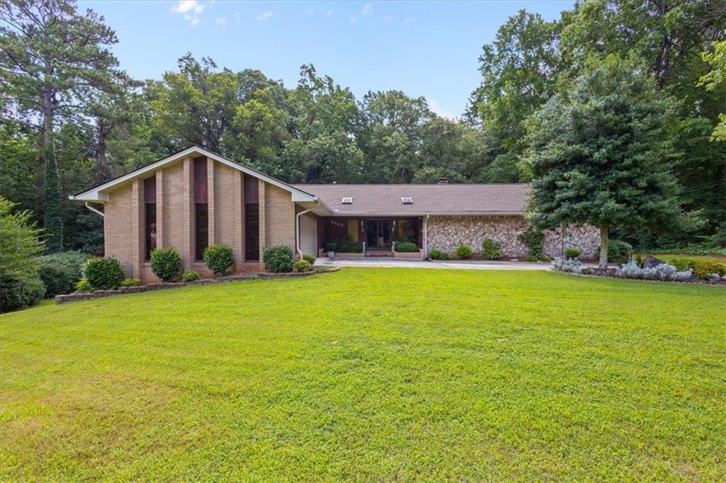 Welcome to 5507 Christi Drive – A Beautifull Retreat in Douglasville*Nestled in a quiet, established neighborhood in Douglas County, 5507 Christi Drive offers over 4,200 square feet of thoughtfully designed living space, perfect for families seeking comfort, space, and convenience. This move-in ready gem blends timeless charm with modern features, all set on a beautifully landscaped lot.*Step into the spacious living room where a soaring vaulted ceiling, elegant crown molding, built-in shelving, and a cozy fireplace create a warm, inviting atmosphere—ideal for both relaxing evenings and entertaining guests.*The kitchen is the heart of the home, featuring a generous island, breakfast bar, sleek stovetop, and classic shaker cabinetry, all accented by refined crown molding. Whether you're hosting friends or enjoying a quiet meal at home, this space is designed to impress.*With four bedrooms and three full bathrooms, there’s room for everyone—plus a dedicated laundry room adds to the home’s everyday convenience.*Downstairs, the full, finished basement opens up a world of possibilities. This versatile space includes a large bonus room, perfect for a home theater, gym, or guest suite, along with a full bathroom for added flexibility and privacy.*Outside, you’ll find a private, fully landscaped backyard oasis—complete with its own second driveway leading to a second garage, ideal for extra storage, a workshop, or parking additional vehicles. The balcony off the main level provides a peaceful view of the surrounding woods, creating a serene backdrop for morning coffee or evening relaxation.*Built in 1974 and lovingly maintained, this home sits on a generous lot and offers a rare combination of space, function, and curb appeal. With its versatile layout and serene setting, 5507 Christi Drive is more than just a home—it’s a place to create lasting memories.