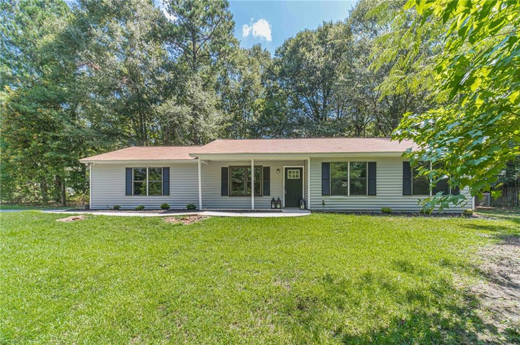 Fully Renovated 3-Bedroom Ranch on Over 1 Acre in Loganville School District – No HOA! This beautifully renovated 3-bedroom, 2-bathroom ranch is nestled on a private, level lot just over 1 acre in the highly sought-after Loganville School District. With no HOA and a secluded setting, this home offers both privacy and peace of mind. Step inside to find brand new luxury vinyl plank flooring throughout, an all-new kitchen featuring stainless steel appliances, granite countertops, and a classic subway tile backsplash. Both bathrooms have been stylishly upgraded, and all light fixtures have been replaced with modern, energy-efficient options. Major systems have been recently updated—roof and HVAC are less than two years old, and the garage door and opener are brand new. Enjoy the outdoors in your fully fenced backyard, perfect for entertaining, pets, or play. This move-in ready gem combines modern upgrades with space, privacy, and top-tier schools—don’t miss out!
