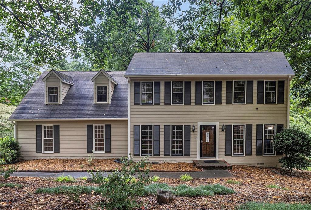 975 Branford Lane NW — a 4-bedroom, 2.5-bath John Wieland Colonial nestled in the established Huntington neighborhood of Lilburn. Situated on a generous 0.72-acre lot, this two-story home offers over 2,500 square feet of comfortable living space with timeless curb appeal and mature landscaping. Step inside to find a spacious and inviting layout perfect for everyday living and entertaining. The main level features a welcoming foyer, a formal living room and dining room, a cozy family room, and a stunning sunroom filled with natural light and serene views of the backyard — perfect for your morning coffee, a home office, or an afternoon retreat. The kitchen offers plenty of cabinet space and flows effortlessly into the breakfast area. Upstairs, you'll find four well-sized bedrooms including a private primary suite with an en-suite bath. With ample closet space throughout, this home provides room for anyone to live and grow as time goes on. Best of all, this home is within walking distance to the Huntington Recreation Club, where members enjoy access to a full Olympic-sized swimming pool — a true hidden gem for outdoor lovers and active families. Located in the Berkmar school cluster with easy access to parks, shopping, and dining, this home is a wonderful find in Gwinnett County. No HOA dues — just classic charm, great community amenities if looking to take advantage, and a spacious serene backyard with wooded views.