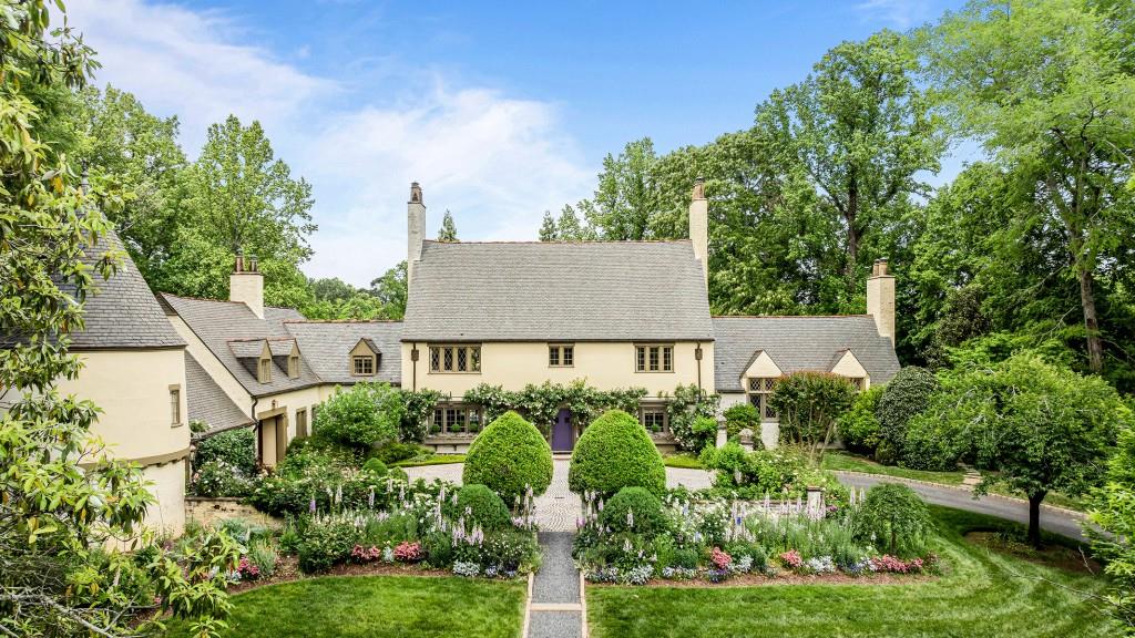 Welcome to a remarkable residence on over 1.5 acres in the prestigious gated community of 675 West Paces Ferry. This exquisite French Normandy home, originally built in 1934 and thoughtfully expanded by Harrison Design, combines timeless elegance with modern luxury. As you approach, you are greeted by beautifully landscaped gardens leading to a grand entry with striking black and white marble floors. The open floor plan is perfect for entertaining, featuring a formal fireside living room, a wood-paneled office, an elegant dining room, and a sunlit bar area. The gourmet kitchen boasts high-end appliances, a separate butler's pantry, and a dining area that opens to the inviting backyard. The expansive owner's suite offers luxurious ensuite amenities, while three additional bedrooms with ensuite bathrooms and an expanded playroom area in the turret complete the second level. The upper floor includes two more bedrooms and one full bathroom. The terrace level features a gym, wine cellar, and billiards room, perfect for relaxation and entertaining. Outside, enjoy several large porches overlooking lush gardens, a flat backyard oasis, and a sparkling pool and spa.  Located in the heart of Buckhead, this home provides easy access to fine dining, shopping, and both public and private schools. Experience the perfect blend of charm and sophistication in this extraordinary property.