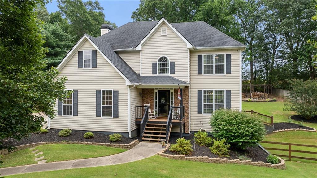 If space, style, and a killer backyard are on your wishlist, this home checks all the boxes—and then some. Sitting on a spacious 0.60-acre lot near a quiet cul-de-sac, this NE facing home has got serious curb appeal with a beautiful elevation that welcomes you home. Step inside to a bright foyer that opens into a formal dining room—perfect for family dinners and holiday spreads—with a picture window overlooking your front yard. Around the corner, there’s a dedicated office with plenty of space to work, study, or create. The heart of the main level is the two-story living room, and it’s a showstopper—massive windows pour in natural light, and the fireplace brings it all together. You’ll love the open layout and luxury vinyl floors that run throughout the main level for that clean, modern vibe. The kitchen is a chef’s dream with granite countertops, a gas range, center island, stainless steel appliances, and more cabinet space than you’ll know what to do with. Right off the kitchen is your breakfast nook—ideal for easy mornings or casual meals. Step outside and summer just got better. Fire up the grill on your covered back porch, catch the game, and enjoy al fresco dinners while soaking in the views of your huge backyard. Kids, pups, and guests will love the swingset, firepit area, and storage shed that’s ready for your tools or workshop setup. At the end of the day, retreat to your spacious primary suite, complete with a double vanity, walk-in closet, and a separate shower for that spa-like feel. Upstairs features three more generously sized bedrooms and a laundry room right where you need it. Need more space? You’ve got it. The finished basement is ready for your media room, guest suite, or even a full in-law setup with a private bed and bath. This neighborhood also brings the fun with a community pool and playground. You’re just 10 minutes from Lake Lanier and 10 minutes from North Georgia Premium Outlets, plus you're in one of the top school districts in Forsyth County.
