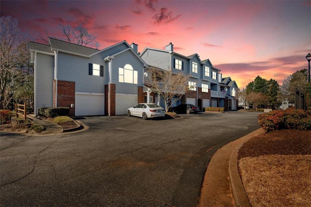 Vinings Forest is one of Smyrna’s most affordable gated swimming pool communities, conveniently located just minutes from The Smyrna Market Village, The Battery, Buckhead, and the airport, and across the street from FOOD TRUCK TUESDAY! This 2-bedroom, 2.5-bathroom unit with a 2-car garage features an ideal roommate floor plan with bedrooms on opposite sides for added privacy. The Dining area and Kitchen have BRAND NEW Hardwood floors, installed July 2025. The kitchen features freshly painted white cabinets, granite countertops, a modern backsplash, and newer appliances. The primary suite also has vaulted ceilings and hardwood floors, en suite bath with a double vanity, a tub/shower, and a walk-in closet. The second bedroom is equally spacious, offering an en-suite bath and a large walk-in closet. The home was recently painted and MOVE IN READY! Residents can enjoy morning coffee or evening drinks on the private covered patio. The oversized 2-car garage, featuring epoxy floors, provides extra storage space. Don’t miss the dog park at the back of the community or this chance to live in Vinings Forest… These units sell quickly!!!