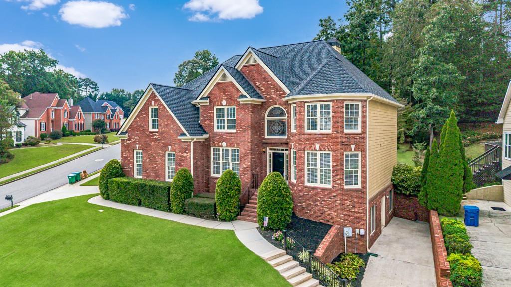This elegant home in Parkview High is what you have been waiting for. It is massive; every room is large. The sellers have prepared it for sale with fresh paint inside and outside, beautiful new carpet, and brand-new appliances in the kitchen. Gleaming hardwood floors are found in the halls, foyer, stairs, great room, breakfast room, and kitchen. Walking into the two-story foyer, you will love all the light from the leaded glass windows. A formal living room, office, or music room is to the right, and a formal dining room that seats 12 is to the left. On the main floor is a large guest suite with a full bath that can fit a king-size bed. The great room has a fireplace with gas logs, built-in bookshelves, and room for one of those extra-large sectionals. The kitchen is a cook's dream with tons of freshly painted cabinets, new quartz countertops, a new backsplash, and brand-new appliances. The appliances include stainless steel double convection/air-fry ovens, a microwave, a 5-burner gas cooktop, and a dishwasher. Upstairs are 4 bedrooms and 3 full baths, including the primary. The primary suite stretches from the front to the back of the house. It has a large bedroom that will fit any suite of furniture, a spacious sitting room that could hold an entire family room suite, a separate exercise room, and a walk-in closet. The primary bath has updated tile on the floors and in the shower, double vanities, a vaulted ceiling, and a jacuzzi tub. The shower features a seat and a frameless glass door. The laundry room has a sink, built-in cabinets, hanging racks, and the washer and dryer remain. The privacy-fenced backyard is level with a lovely patio surrounded by a low brick wall, and there is beautiful landscaping. The two-car side-entry garage has a freshly painted floor. The basement is unfinished and stubbed for a bath. There is a workshop sink in the basement and a second driveway that makes bringing tools or supplies to the basement a breeze. You will love this house!