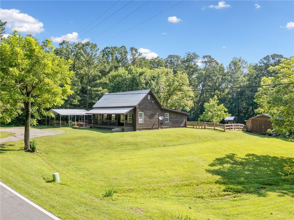 Welcome to Southern Simplicity. Ranch. No HOA. No restrictions. Just freedom, fresh air, and farmhouse peace. Step back in time and fall in love with this picture-perfect 100+ year-old farmhouse nestled on 3.48 acres of pure country freedom! Overflowing with rustic charm and character, this 2-bedroom, 2-bath beauty brings the best of both worlds: timeless appeal with modern comfort. Under a classic metal roof and behind a rocking chair front porch, you’ll find original touches that whisper stories of generations past—alongside thoughtful updates that make everyday living easy. Kitchen features farmhouse style sink, granite and butcher block counter tops, island with seating, and open to living room. Cast a line in your very own private pond, gather fresh eggs from your free-range chickens, create your dream mini-homestead—there’s room for ducks, goats, horses, and more. Enjoy wide-open space with endless possibilities—gardening, four-wheeling, bonfires, or just breathing it all in. This is not your cookie-cutter house—it’s a one-of-a-kind experience that wraps you in warmth the minute you arrive. Whether you're looking for a weekend escape or full-time country living, this rare gem delivers.
Located just minutes from historic downtown Cartersville with restaurants and shopping, the LakePoint Sports Complex, and I-75—you’re close to everything, but with all the peace of the country. Schedule your private showing today—homes like this don’t come around often!