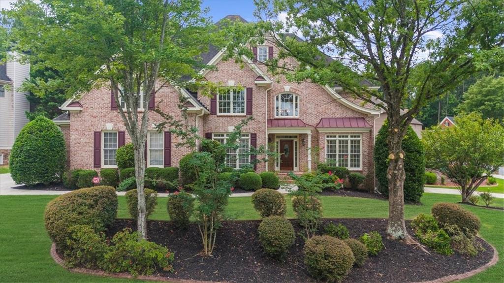 Welcome to 6031 Addington Dr., in the coveted Brookstone Country Club Community! This three-sided brick home is situated atop a beautiful pie-shaped homesite. Not only does it offer a 3-car side-entry garage, but there is an additional 4th car door located in the rear yard on the basement level--perfect for golf carts, ATVs, or a large workshop! This home offers newly finished REAL hardwood floors, brand new luxury carpet, and fresh paint throughout. You will be welcomed into the stunning two-story foyer showcasing brand new hardwood treads and wrought-iron railings on the stairwell. Main level includes private bedroom w/ ensuite bath, perfect for an in-law suite or even a main level office. In the gorgeous kitchen, there are white cabinets with a beautiful wooden vent hood, stunning quartz countertops, expansive island w/ wine cooler, pretty tile backsplash, walk-in pantry, and stainless appliances. The two-story great room is open and bright with built-in bookcases and beautiful hanging chandelier. The designated dining room is perfect for hosting large dinner parties. The front living room has so many possibilities, including a welcoming office area. Upstairs in the oversized owner's suite, you'll find your own sitting room with a cozy fireplace. In the owner's bath, you'll find a large double vanity with sitting area, separate tub/shower, and his/hers closets. One secondary bedroom offers an ensuite bath, while the other bedrooms are connected by a Jack and Jill bathroom. The basement includes brand new luxury vinyl plank, a spacious entertainment room, full bath, potential gym, plenty of storage space, and the additional 4th car garage. The oversized deck is perfect for grilling out or entertaining outside. Top rated Schools of Pickett's Mill Elem./Durham Middle/Allatoona High. While Brookstone offers a clubhouse, swimming pool, playground, tennis/pickleball courts, basketball court, and play field, you also have the option of joining Brookstone Country Club. Brookstone Golf & Country Club offers an 18-hole Larry Nelson-designed golf course, full driving range, two chipping areas with practice bunker and large putting green, pro shop, and golf calendar events. For tennis or pickleball players, there are eight lighted tennis courts including two clay courts and 4 dedicated pickleball courts. Brookstone includes a Junior Olympic-size swimming pool and separate adult pool. Take advantage of the Members' grill for casual dining and full calendar of social events. The gym includes state-of-the-art strength and cardio equipment. Exercise classes encourage motivation through live, instructor-led classes room. Get a full-body workout as you enjoy your favorite fitness program, including yoga, Pilates, barre, and boot camp. This is a unique opportunity for a fully renovated home in a highly desirable community with top-rated schools--schedule your appointment today!