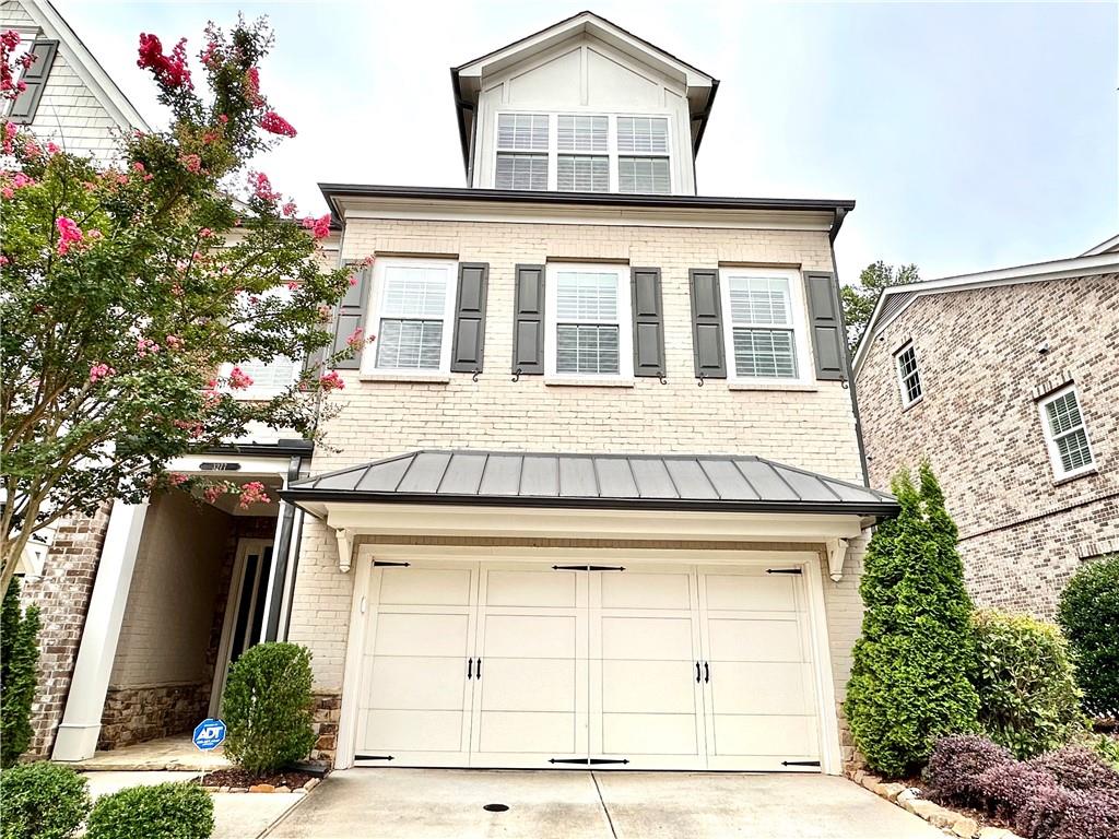 Stunning Townhome in Gated Community loaded with many upgrades. Step into this Elegant 3715 Sqft End-Unit townhome in a premium location close to shopping and restaurants. Featuring 4 beds and 3.5 baths, gourmet kitchen with extended quartz island, brick and shiplap accent walls, stainless appliances, tray ceilings, 6.5" hardwoods throughout first two floors and stairs, and a luxurious owner suite with sitting area and SPA-quality bath, elegant master bath with a stand-alone tub and a large frameless shower. Oversize guest suites and bonus media/flex room on the third level with a convenient kitchenette— perfect for a media/gaming/hobby space, in addition to another guest bedroom and full guest bath. Additional highlights include a central vacuum system for effortless cleaning, plantation shutters, custom storage & closet systems, and Elevator shaft closets on all three levels provide opportunity for elevator installation or convenient storage space. Outside, relax on your private and fenced backyard. Community boasts clubhouse, outdoor fire pit area, swimming pool, and HOA-covered landscaping, lawn maintenance, all in a pet friendly, gated community with top-rated public schools.