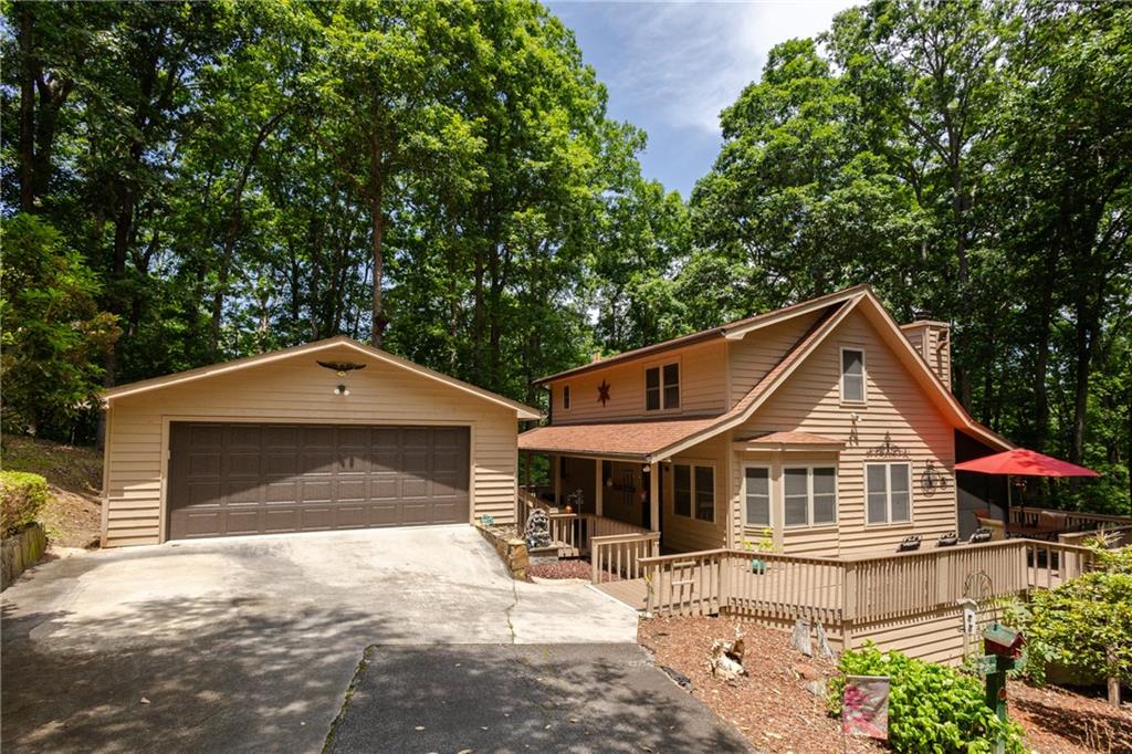 NEW HVAC, NEW SEPTIC SYSTEM, NEW KITCHEN APPLIANCES, ALMOST 2.5 ACRES....MINUTES TO LAKE NOTTELY....THIS IS YOUR NEW PLACE TO CALL HOME! The lovely kitchen features stained cabinetry, brand new appliances, and breakfast bar. Separate area for breakfast table/dining area with view to living area. Open family room features stone surround and raised hearth fireplace with gas logs, vaulted ceiling, plenty of sunlight, view of loft area, and access to screened in deck that covers the entire back side of the home. Large bedroom with access to back deck, full bathroom, large laundry room with wash sink finish out the main level. Upstairs you will find the large loft area overlooking the family room. Owner's suite with ceiling fan, full bathroom, and walk-in closet. The partially finished basement has a third full bathroom, bedroom, and second laundry area, plus tons of unfinished room for storage or to finish out as you desire. Oversized exterior door leads you to the fully functioning detached workshop with full wrap around deck. Additional features include full wrap around deck, screened in back deck, covered walkway/steps to detached 2 car garage, circular driveway, plus so much more.