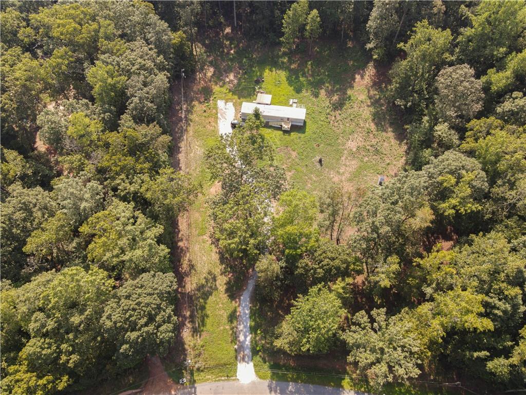 Your Private Paradise Awaits on 2.12 acres in Madison County! 2 bedroom, 2 bathroom mobile home on foundation. Brand new well pump, all new plumbing. New 6 x 8 front porch with ramp. 12 x 12 back porch. New ductwork already in place for new system installation. Hardwood floors main living areas. Spacious bedrooms. Lot recently cleared and seeded with grass. Septic system recently serviced. Large, private lot.