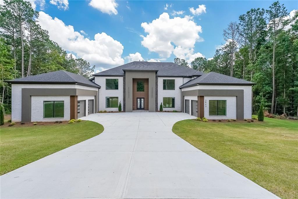 Exceptional new construction in Buford City Schools! This is the one you have been waiting for! AND NOW A MARKET ADJUSTMENT TO GIVE A GREAT NEW PRICE! Modern detailing and stunning design from the smallest of details to the big open floor plan. Fabulous, sprawling, and private 2.2-acre lot is the perfect place to build your outdoor dream whether it be a large garden, a swimming pool oasis, or a private tennis court, there is more than enough space to bring your outdoor vision to life! The curb appeal is fantastic with the on-trend colors and wood trim. Walk through the front door and find the light-filled spaces perfect for entertaining and comfortable family living. The spacious kitchen is gorgeous plus the scullery (or second kitchen) is a dream come true for the chef in your family. The spa-like master bathroom is exquisite and the master closet is extra spacious! Upstairs are 4 bedrooms with ensuite bathrooms and large walk-in closets. The terrace is huge and full, and waiting for your personal finishes. Enjoy the covered and uncovered decks on the back of the house. This is a unique opportunity to own gorgeous new construction on a private 2.2 acre lot in this tranquil area surrounded by mature trees and lush greenery tucked away from the hustle and bustle of life. CONSTRUCTION IS NOW COMPLETE AND HOUSE IS READY FOR ITS NEW OWNER! NOTE: Gravel road is temporary access during construction of the five lots on the road. Once all homes have been completed, the road will be paved. Also, builder has started the process to add a private gate at the front of the property with a fence around the front of the property.