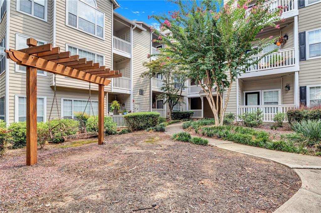 Welcome to this charming, 1st level studio condo in a gated community that offers both convenience and lifestyle! Ideally located just minutes from Truist Park, The Battery, plenty of shopping, dining, entertainment and only a short drive to Downtown Atlanta. Step inside to find an open concept layout featuring a white Murphy bed, an oversized closet, and stackable washer/dryer for everyday convenience. The kitchen is complete with granite countertops, plentiful cabinet space, and a breakfast bar, perfect for meals. The Community amenities include a swimming pool, clubhouse, fitness facility, tennis courts, and scenic BBQ/picnic areas for gatherings with family and friends. Perfect opportunity for a college student, first-time buyer, or investor looking for low-maintenance living in an unbeatable location.