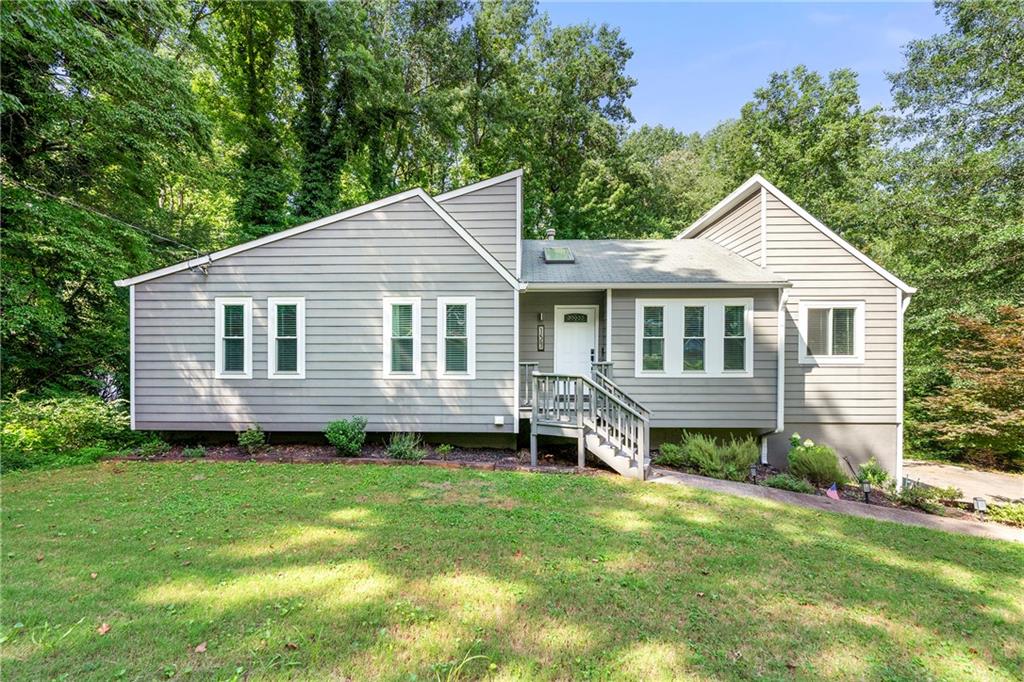 Welcome to this beautifully updated home on a spacious half-acre lot with no HOA, offering a perfect blend of comfort, style, and functionality. Inside, you'll find an open-concept layout with high ceilings and updated flooring that creates an airy, inviting feel throughout. The heart of the home is the completely renovated kitchen featuring abundant storage, quartz countertops, subway tile backsplash, new lighting, a breakfast bar, and a seamless flow into the main living space. Fresh neutral paint, board and batten wall accents, and an updated mantle surrounding the cozy fireplace add warmth and modern charm. The primary suite is a relaxing retreat with a spa-style bathroom and an upgraded closet featuring a new shelving system. Two additional bedrooms and a full bathroom complete the main level, all bathed in natural light. Step outside to enjoy the large deck overlooking a private, fenced backyard—ideal for entertaining or unwinding around the new firepit. Enjoy deck access from both the living room and the basement, offering easy indoor-outdoor living. Additional updates include new gutters, updated interior door hardware, and thoughtful touches throughout. All of this is ideally located in Woodstock, just minutes from Marietta, Roswell, Highway 92, and top-rated schools. This move-in-ready home is a rare find—don’t miss the opportunity to make it yours. Special financing available, ask Listing Agent for details.