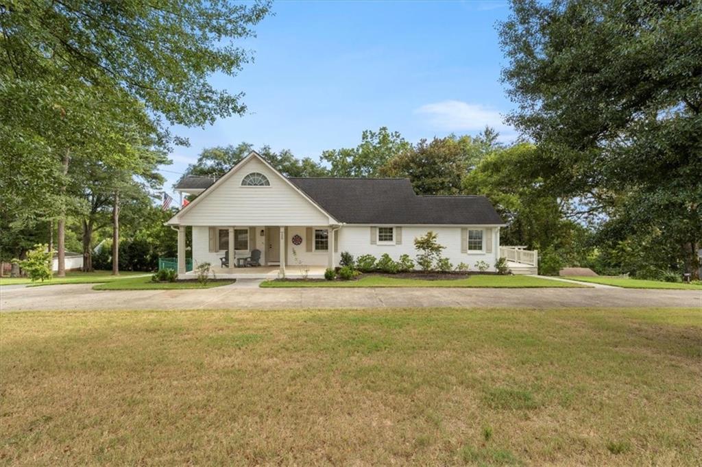 Welcome to this beautifully remodeled home on the corner of Pisgah Way and Buena Vista Drive. Updated two years ago, this property sits on a half-acre lot with a fenced backyard and stands out as a focal point in the neighborhood. Inside, the family room features a brick fireplace with built-in bookshelves, and the home offers four bedrooms with refinished oak hardwood floors and luxury vinyl plank upstairs. The primary bathroom is modern with a soaking tub and tile shower. The large back deck overlooks the sunsets over downtown Calhoun, while the upstairs balcony is the perfect place to enjoy the sunrise with morning coffee.