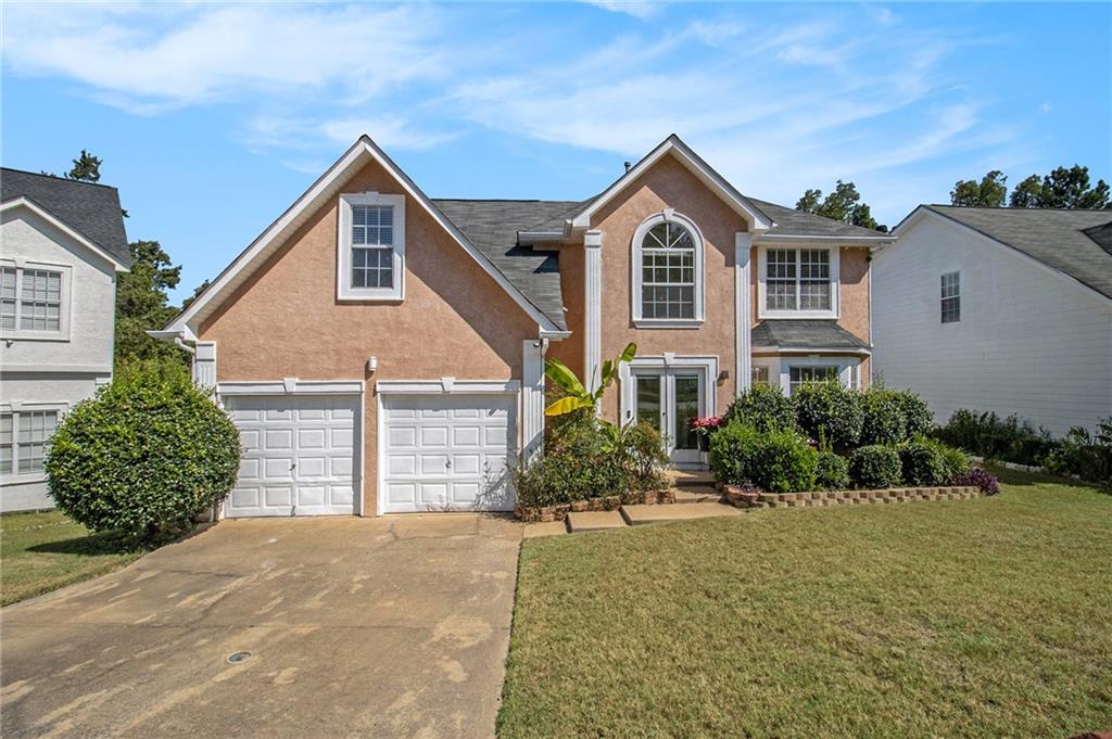 Nestled in the privacy of a tranquil cul-de-sac, this distinguished Stone Mountain residence blends timeless design with modern upgrades for today’s lifestyle. Set on a generous, level lot with an expansive front, side, and backyard, the property offers both beauty and functionality in an established neighborhood setting.
Upon entering, you are welcomed into a flowing main level featuring multiple living and entertaining spaces, including a formal living room, a cozy family room, and a separate dining area. The chef’s kitchen is appointed with sleek granite countertops and seamlessly ties the spaces together—perfect for both intimate meals and hosting guests.
Upstairs, discover four spacious bedrooms, each enhanced with ceiling fans and hardwood flooring. The oversized owner’s suite is a retreat in itself, offering abundant space for a private sitting area and restful comfort. Bathrooms are tastefully finished with granite counters and tile, providing a touch of luxury in everyday living.
Additional features include backup emergency power for added peace of mind, a full security camera system, and an expansive outdoor space ideal for gatherings or quiet enjoyment.
Perfectly situated with convenient access to top schools, shopping, dining, and recreation, this home is only moments from Stone Mountain Park, Tucker, and Snellville.