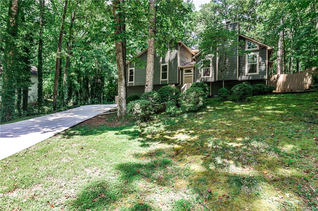 Cozy Cabin Vibes Near the Silver Comet Trail! Tucked at the end of a quiet cul-de-sac, this beautiful home offers rustic charm and modern comfort in a serene setting. Just minutes from the Silver Comet Trail, enjoy outdoor living with a stunning flagstone patio and a spacious screened-in porch. Inside, the open floor plan features a vaulted great room with a wall of windows, stone fireplace, and tons of natural light. The large kitchen includes granite counters, stainless appliances, stained cabinets, a walk-in pantry, and a window overlooking the backyard. The oversized master suite has an updated bath with granite vanity and tiled shower. Spacious secondary bedrooms include large closets, and the finished basement offers a huge bonus room, full bath, and plenty of storage—ideal for guests, office, or gym. This one is full of character and ready to welcome you home!
