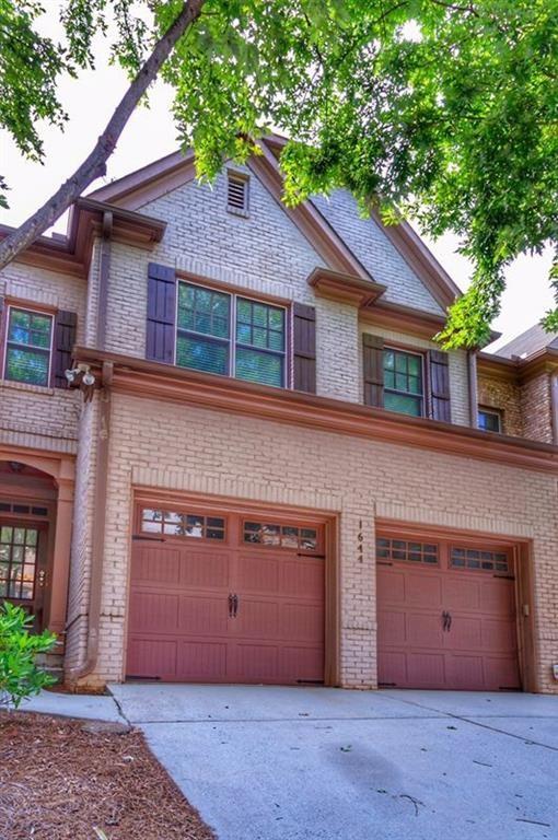FRESHLY PAINTED AND BRAND NEW CARPETS. Drop dead gorgeous town home. Warm stone & brick entrance to the home welcomes you. Fab two-story open foyer. Warm family room w/ fireplace & large bank of windows. Large beautiful higher end kitchen. Outside deck is private. Large and finished terrace level includes the 4th bedroom w/ full bath PLUS media/great room. (Finished Terrace Level adds to amount of sq. footage published tax records.) Perfect for family, young professionals, live/work, or roommate. Clean, fresh, beautiful, and ready to be called home.