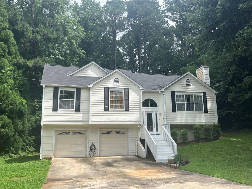 This home is located in one of the most highly desirable areas of Paulding County- less than a mile to the Cobb County line. Near shopping, restaurants, and parks, this home is located in a quiet, NON-HOA neighborhood with larger lots, and a scenic, beautiful road to access the neighborhood. Roof is 4 years old, HVAC is 3 years old, and termite bond and HVAC Service contract have been kept up by the seller. Seller has also had boards replaced on back deck, had work done on front deck, and had septic tank pumped recently. Home also has upgraded lighting in the main areas, as well as solid hardwood floors through-out main living area, that just need to be refinished to be returned to their original beauty. This home is in need of some cosmetic TLC, as the walls are in need of painting (patching has already been done), kitchen cabinets are in need of replacement or repair, flooring in bedrooms and laundry room need to be replaced, and exterior needs to be painted. This would be a perfect home to build some sweat equity, as it is very livable and has had the systems and roof maintained and just needs someone to come in and paint and put down flooring of your choice and you will have a great home in a great area!