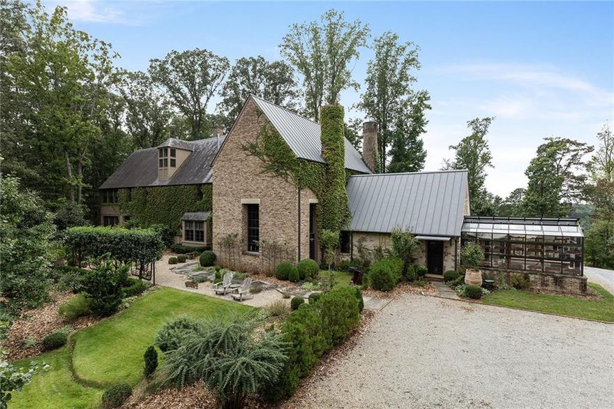 A rare opportunity to own a very unique property!
Absolutely stunning Old European meets New Belgium country manor home situated on 52 +- quiet rolling pastured and wooded acres with views in every direction! Designed by world-class architect Peter Block and custom built by A-list builder Bobby Garrett of Garret Ingols, this home and property is what dreams are made of.  With an abundance of indoor-outdoor access, combined with stone patios, gardens and views beyond, this home is fully anchored into the landscape on all sides. An all-plaster interior with a light-filled great room boasting French windows, a fireplace, multiple sitting and dining spaces, and an expansive barrel-vaulted ceiling gently illuminated by tiny fiber-optic light lenses. An adjacent ‘cathedral kitchen’ with restaurant quality appliances includes a 7 foot long Lacanche French range with custom hood, open brick cooking fireplace with operable cooking grate, commercial refrigeration, open storage for ease of access to all the cooking supplies needed. This commercial grade kitchen also includes scullery quarters which further leads into the larder, pantry, laundry, guest bath, greenhouse and culinary garden beyond.  In addition to the main floor is the entry room with adjacent powder bath, private gathering room with a fireplace, a separate inglenook sitting area surrounded by books and a wood burning stove overlooking the front garden and landscape. Through the primary hall is a books hall and gallery guiding you to the guest bedroom fitted with a wood burning hearth and en-suite bath.  Additionally, there is a laundry room, expansive screened in porch set amongst the forest with a fireplace and ample seating for dining and lounging.  Ascend the main staircase to the second level to discover the owner’s suite with a vaulted ceiling, wood burning stove, sitting area, and large en-suite bath with custom stone sink and extra-large shower room. Attached to the bedroom suite is a large private wardrobe room with a private outdoor space perfect for meditation or a morning cup of coffee. Down the mezzanine is a double bedroom fully wrapped in windows on three sides creating a veritable sleeping porch within the tree canopy with an attached en-suite bath.  Up via the side hall stair is the third story tucked under the roof line with a cozy media room/office and fourth bedroom which can also be used as a yoga-meditation space or studio complete with an en-suite powder room. Additional amenities include gated entry, security system, high-speed fiber optic internet, geo-thermal heating and cooling, radiant floor heating, solar panels, whole-house generator, UV water filtration system, covered parking plus multiple parking spaces, yoga platform, and children’s tree fort.