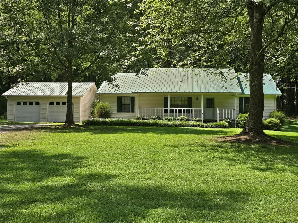 Adorable ranch home with a 2-car detached garage sitting on 2 pristine beautiful acres ready for your enjoyment! Split bedroom plan. Large great room with vaulted & beamed ceiling. All bedrooms have walk-in closets. Large laundry room. Deck overlooks gorgeous private back yard. No pets and no smokers. Security deposit & 1st month's rent due up front. Tenant responsible for yard.