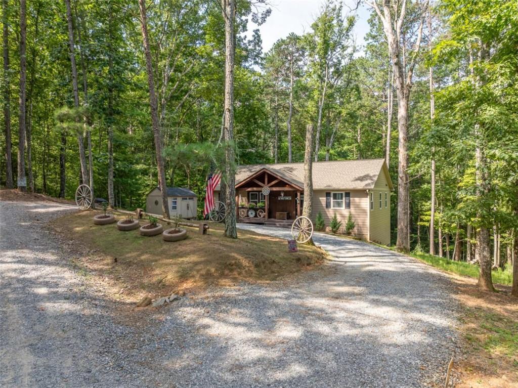 Step into comfort and style with this beautifully maintained 3-bedroom, 2-bathroom ranch home, only 3 years young! Located just minutes from the river and ready to welcome you home!! This home offers a peaceful retreat with thoughtful upgrades throughout. The open-concept living area offers cozy gas log fireplace, perfect for relaxing or entertaining. The kitchen is a chef's dream-featuring custom soft-close cabinets, granite countertops, a central island, and stainless steel appliances. A large laundry/pantry room adds functionality, while cute accent barn doors give the home added charm and character. The primary suite comfortably fits a king-size bed and boasts a luxurious bathroom oasis complete with a grand tile shower with rain head, Bluetooth speakers, double vanities, and a massive walk-in closet perfect for any wardrobe or shoe collection. Two additional spacious bedrooms on opposite side of home share a beautifully tiled bathroom with a tub/shower combo. Enjoy morning coffee on the covered front porch with slight river sounds in the background, or host gatherings on the open back deck overlooking nature. A horseshoe driveway makes for easy access and extra parking, and the shed is perfect for extra storage or a workshop. Additional storage in the standing crawl space area. Amenities such as river access, pickleball, gated entrance, 3 pools (one indoor), tennis/basketball courts, mini golf, parks, pavilions, and walking trails. In the heart of wineries, eateries, antique stores, hiking and biking.
