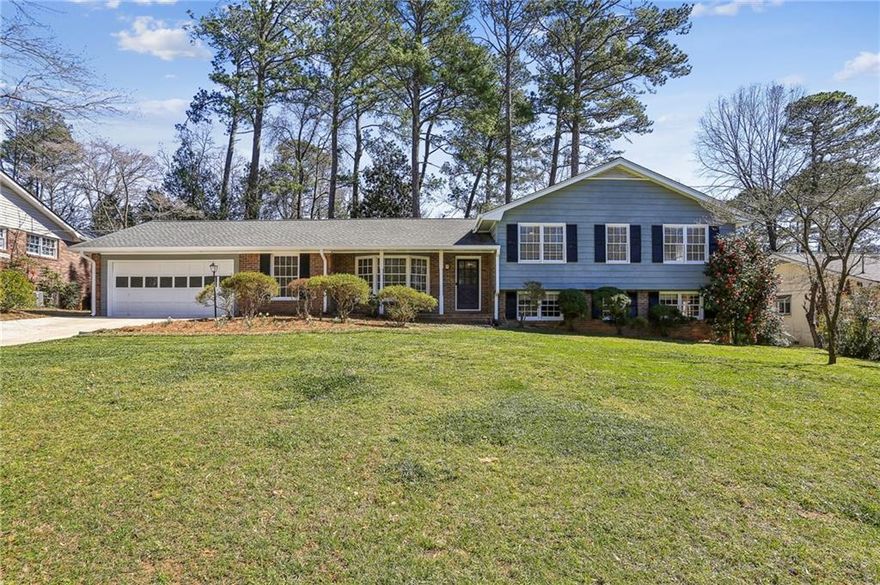 A spacious and sunny split-level home awaits you in the charming Stratford/Grove Meade/Hyde Park neighborhood of East Cobb. The well-manicured lawn, with a bed full of flowering plants, invites guests to the front door and a small entrance foyer. The front living room, with bay windows, was used by the previous owners as a home office. The large kitchen features granite countertops, custom cabinets, a work island with a hanging pot rack, and a breakfast bar. The open kitchen/family room provides endless opportunities for entertaining, family time, and cozy get-togethers in front of the fireplace. This home has been freshly painted inside and out, and new carpet and luxury vinyl flooring were added. Up a small stairway are three bedrooms, two full bathrooms, and a vanity area. The primary bedroom, with original hardwood flooring and an ensuite bathroom, overlooks the backyard and is quite large by neighborhood standards. The two bedrooms in the front are connected by a full bathroom. Heading downstairs from the family room is a sunny walk-out basement; the finished half makes for a great office, teen hangout, or an extra family room. The unfinished half offers expansive storage options and is stubbed for future conversion into two additional rooms and a full bath - perfect for an in-law suite. A new driveway leads to the two-car garage that contains custom-built shelving and access to the kitchen and backyard. A hidden fence and evergreen foliage enclose the private backyard and patio - great for kids and dogs to play safely and for hosting parties and family cookouts. A sunny pocket garden offers the opportunity to grow fresh flowers and vegetables. The backyard is traversed by an irrigation system that can assist gardeners with their activities. The neighborhood offers an active, voluntary HOA which organizes frequent activities for the residents; one block from the house is the Meadowgrove Swim and Tennis Club with a vibrant membership, quality tennis courts, and a swimming pool open from mid-May through Labor Day. This wonderful, quiet community is conveniently located near I-75/285, The Battery/Truist Park, and numerous shopping, dining, entertainment, faith, and recreational options.