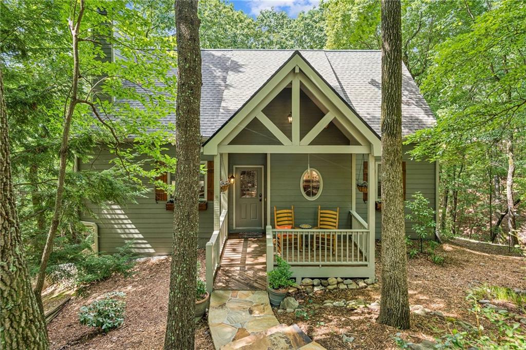 Charming Cul-de-Sac Home in Big Canoe! Offering privacy, quality, and tasteful updates, this home is move-in ready and designed for relaxed mountain living.
Welcome to 121 Laughing Fox Knl — a beautifully maintained 4-bedroom, 3-bath home tucked at the end of a quiet cul-de-sac in the prestigious Big Canoe community. Located near trails and creeks-Indian Rocks Park.
Soaring vaulted wood ceilings in the Great Room with a stunning floor-to-ceiling stone fireplace and expansive windows that flood the space with natural light
Open-concept layout connects the cozy kitchen and breakfast bar to the living area — perfect for entertaining
The loft has additional space for office, crafts or quiet time.
There is no lack of storage space in this home.
New fixtures, hardwood floors (2023), and a host of stylish finishes throughout.
Primary suite features an updated master bath (2016) and serene views of the surrounding woods.
Enjoy the fresh mountain air from the screened-in porch and adjoining deck.
Professionally landscaped yard with retaining wall and screened in patio, outside grilling patio (2020) and a newly added parking pad and walkway (2019).
Roof replaced in 2025.
New appliances: Stove (2024), Dishwasher (2023), Fridge (2022), Washer/Dryer (2016) Main Level Laundry room with sink.
Windows and porch doors replaced in 2018.
Furnace & dual-fuel AC system (2021).
Exterior painted (2023), gutters and guards (2016), and rerouted dryer vent (2022).
Terrace level has a family room, bedroom and screened patio for the family or guests to spread out.
The terrace level is already plumbed for a bath and ready for your finishing touches—ideal for a game room, guest suite, or media area.
This home blends comfort and craftsmanship in one of Big Canoe’s most desirable settings. Whether you're looking for a full-time residence or a weekend escape, this property checks all the boxes. Furnishings available under a separate bill of sale.
***A mandatory $4,500.00 capital contribution fee paid by the purchaser to the Big Canoe Property Owners’ Association will be due at closing. Pursuant to Article II, Section 1, Paragraph bb of the Class “A” Covenants for the Big Canoe community, all property transfers are subject to the Big Canoe developer’s right of first refusal.