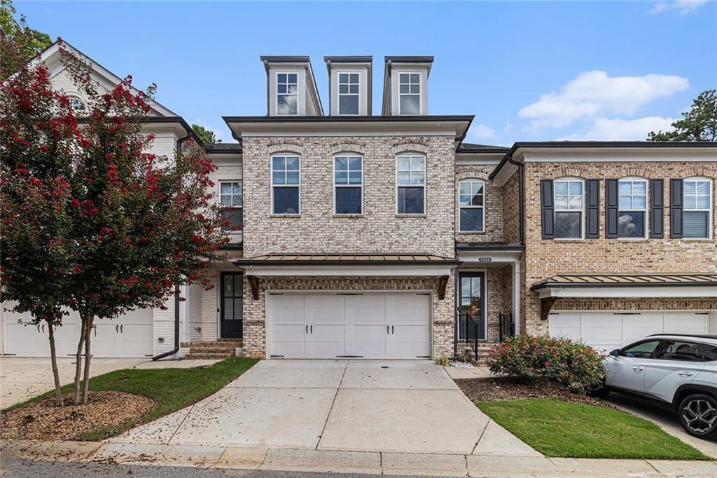 Stunning Farmhouse-Inspired Townhome! You'll approach through the gated entry to this immaculate, architecturally stunning community. Home features wide plank hardwood floors balanced with silvery-white living spaces including chef's kitchen w/ sleek quartz countertops, stainless appliances, subway tile, gas cooking w stainless vent, massive breakfast bar, island with sink, pendant lighting, large open dining, family room w/ batton board millwork and wall of windows overlooking the ultra private fenced backyard. Entertaining expands to covered patio, custom fencing lined by a canopy of trees. Owners suite w trey ceiling, double french doors to tile bath, massive spa shower, separate quartz vanities, two secondary bedrooms and bath with double sinks, carriage style 2 car garage with additional storage added by Seller. Imagine owning this stunning home in the best spot in this quiet neighborhood with walking path and pond, minutes to Roswell Area Park, Downtown Roswell, Crabapple, Alpharetta and Avalon. All this and more with Top Rated Schools.
