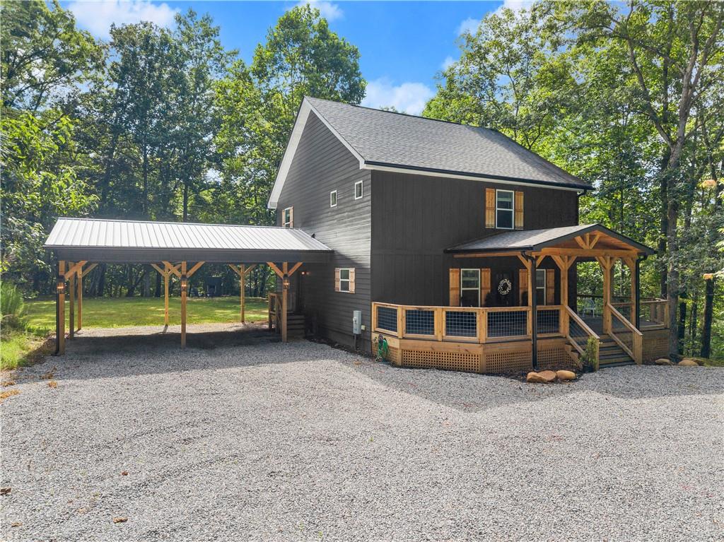 Better than new, uniquely styled, classically updated, customized farmhouse, on 1.7 acres, in the Historic Gold Mining town of Dahlonega, Ga. This one of a kind home is a true show stopper. Perfectly situated on a level knoll, surrounded by native foliage, with an expansive and level backyard, dripping with privacy, the 4 bedroom and 4.5 bathroom home is every homeowners dream. The front entry boasts a generous open concept living room, dining area, and chefs kitchen, complete with exclusive white cabinetry, granite countertops, new appliances, and a hand hewn farmhouse table, perfect for family gatherings and entertaining. In addition, the owner has spared no expense in designing a must-see personalized butlers pantry and drop zone, just off the kitchen. An oversized owners suite is also located on the main level, just off the living area, complete with walk-in closet, and it's own private en-suite bathroom. Venture upstairs to find 3 perfectly appointed, oversized bedrooms, each with its own private bath. The exterior is complete with Hardie Siding, wrap around porch, oversized carport, fire pit, and garden area. The layout makes this home a perfect layout for large families, affordable executive style living, sub-leasing upstairs bedroom/bathroom combos, and mid to long term rentals. The entire home has been stylishly renovated and updated with new fixtures, accent walls, designer tile, luxury flooring, updated cabinets and countertops, fresh paint throughout, a uniquely crafted butlers pantry, new driveway and driveway improvements. This home is MOVE IN READY and strategically located within the city limits of Historic Dahlonega near many wineries, river tubing, trout fishing, hiking, University of North Ga College, main street restaurants, and the Appalachain Trail. Come for a weekend, and stay for a lifetime. This home is calling you, don't delay. Professional photos coming soon.