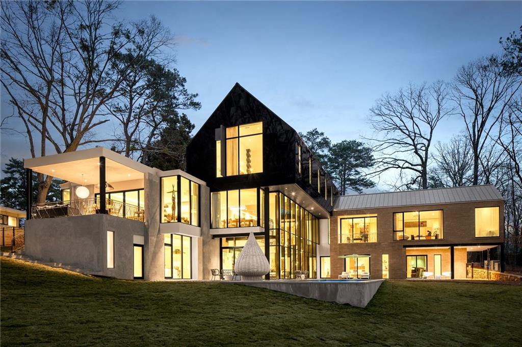 New Construction modern residence is designed and perfectly sited to maximize the incredible views of the property and the 65 foot pool on a private, flat 1.06 acre lot in Buckhead. Inside as the sun reflects off of the pool, reflections of light move across the ceiling throughout the day through the 3 story glass curtain wall by Reynaers (Belgium) by Expert Window and door. The kitchen,designed by Design Galleria is exceptional with Temmer marble counters and a hidden walk in pantry.Steam Wolf oven, Sub Zero and custom cabinetry by Kingdom. The main entrance and lower doors are pivoting by La Cantina. Exterior brick is Meridian brick and the black reflective wall panels, the first in the US are Nichiha Miraia panels by Legendary Exteriors. The plumbing fixtures are by Porcelanosa and Dornbracht. The finish level is excellent and is a collaboration between ADCO Properties, Harrison Design and AIA architect Robert Tretsch. The main living room space has a full bar,game room with fireplace, 2 bedrooms/bathrooms that open out to the pool. The master bedroom suite is on the main level with study and separate dressing rooms. The upstairs features 2 bedrooms/baths and an additional laundry room. This home is energy efficient and completely wired for whole house automation. Elevator shaft and 3 car garage near the kitchen.