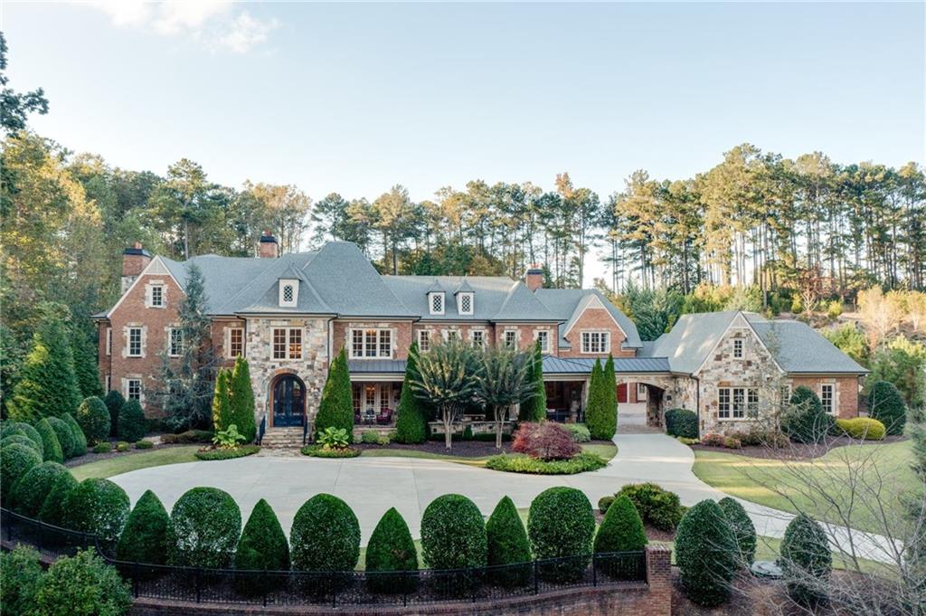 This is an opportunity to own one of Atlanta’s most prestigious masterpiece estate homes. Glenayre is an exclusive gated and guarded community just 15 minutes north of Buckhead. Located in a private cul-de-sac on 3.66 manicured acres. This stately mansion features four sides brick and stone with abundant architectural details. Circular driveway and porte cochere lead into a paver lined motor court with access to six garages plus a full mechanic's workshop. The interior features three full levels of custom living space with extensive upgrades and plenty of luxury living space. Breathtaking two story foyer with an open circular staircase. Dramatic two story library/office with custom bookcase, fireplace, rear spiral staircase and elevator. Banquet size dining room. Two story formal living room with fireplace. Chef's kitchen with commercial grade appliances, butler pantry with custom cabinetry and built-in desk overlooking breakfast room, two story family room with fireplace and a wall of windows with views of the amazing pool and manicured backyard. Luxury master on the main with ALL the bells and whistles. Large laundry room with custom cabinetry. Second floor boasts four master suites plus a one bedroom au pair apartment complete with gourmet kitchen, and second laundry room. The finished terrace level offers a theater, billiard room, gorgeous bar, gym, sauna, fireplace and one and a half baths. Walk out from the main level into paradise! This beautiful area features a stone and brick lanai with built-in kitchen, fireplace, T&G ceiling, saltwater Pebble Tec pool with hot-tub, waterfall. Too much to list a must see for your most discerning buyer!