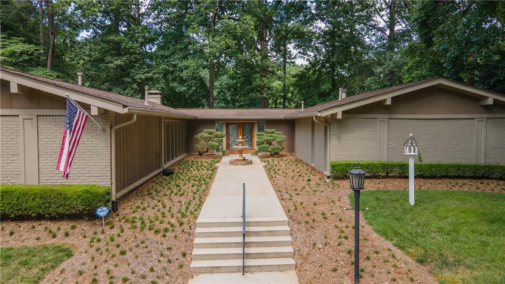 Come see this charming 4 bedroom / 2.5 bath lake front oasis, in Brookhaven! Drive up to the property on the circular driveway. Once you are out on the grounds, you will walk past the fountain as you make your way through the courtyard, to the front door. When you enter the house into the light filled entry foyer, you will see the spectacular lake view. This home has a separate living room w/fireplace, a separate dining room, a den w/fireplace & bar, kitchen w/granite counters, maple cabinets, stainless steel appliances, pantry area w/freezer and a breakfast room. The primary bedroom has a fireplace, exposed brick wall and view of the lake. The primary bathroom has a large vanity, walk-in closet and sunken tub / shower. There are three additional large bedrooms of which one is currently used as an office. This bedroom has a private courtyard off the side of the house. You will find a half bath near the kitchen and full bathroom off the hallway close to the bedrooms. There is a large laundry room w/storage, a side entry garage w/tons of storage and plenty of attic space. Out to the side of the house you will enjoy sitting next to the private swimming pool, on the patio staring at the lake. Walk around back to an additional patio and then to the courtyard on the side. Stroll down to the lake and sit on the bank for total peace and quiet. Make an appointment today to see this awesome home!
