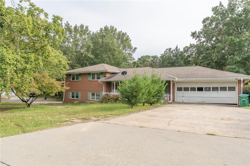 Location! Location! Move-In Ready! This fully brick mid-century charmer sits proudly on a beautiful corner lot with a brand-new roof. Solidly built and full of character, it’s designed for both comfort and style. The main level offers a bright and welcoming layout, while the finished basement with 2 bedrooms, 1 bathroom, and separate access adds flexibility—great for extended family, guests, or rental potential. Perfectly positioned near City Hall, Groceries, fire station, post office, Buford Hwy, and major arteries, you’ll enjoy easy access to everything Norcross and Atlanta have to offer. Don’t miss the chance to call this versatile and charming home yours—schedule a tour today!
