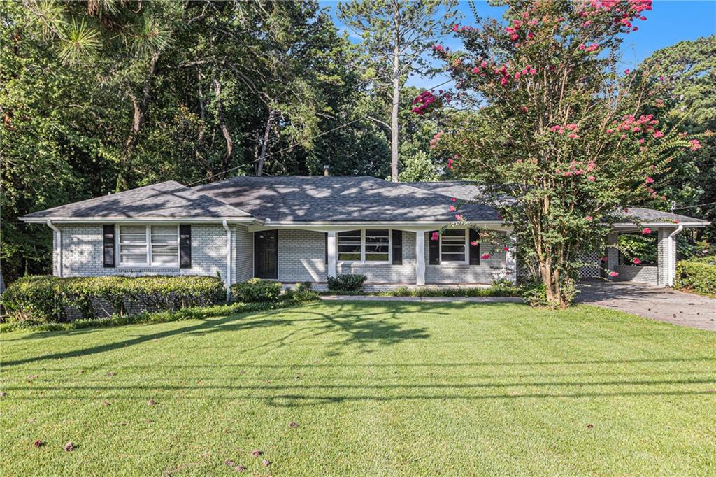 Live in the heart of it all! Ideally located on Shallowford between I-85 and Briarcliff, this renovated ranch puts you just minutes from Brookhaven, the CDC, Emory, Mercer, and I-285—an unbeatable Atlanta location! Step inside to find a beautifully updated open kitchen featuring solid surface countertops, stainless steel appliances, and a stylish tile backsplash. Dark walnut hardwood floors flow seamlessly throughout, complemented by ceramic tile and modern grey-and-white tiled bathrooms. Downstairs, you’ll discover a private finished office space—perfect for remote work—plus a spacious unfinished area ideal for storage or future expansion. Outside, enjoy an oversized, park-like backyard that’s perfect for BBQs, entertaining, or simply relaxing. This home truly offers the best of location, style, and functionality. Don’t miss your chance to make it yours!