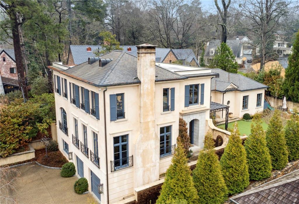 This sophisticated renovation by Michael Ladisic of the original 2003 home designed by Yong Pak is a timeless masterpiece. Towering ceilings, dramatic details, windows and front door imported from Belgium, gorgeous re-claimed hardwood floors, and custom refinements too numerous to mention define every inch of this exceptional home. In 2018, Ladisic, with the help of designer Nancy Race, oversaw the transformation of the second floor into an incredible owner's suite, featuring a fabulous fireside bedroom, stunning marble bath, and unprecedented, custom-fitted walk-in closet. That same year the kitchen was renovated to the highest level of discernment, including brass fixtures, custom iron windows, steam oven, warming drawer, La Cornue 5 burner gas range, one-of-a-kind range hood, double Miele dishwashers, and walk-in pantry with antique French doors. Additionally, the property includes a soaring stone-floored entrance hall, a great room with a huge antique fireplace which is open to the light-filled dining room, a fireside family room which is open to the kitchen, and a breakfast room overlooking the covered patio. There are also two ensuite guest bedrooms on the main floor, one an optional primary suite with decorative fireplace. Off of the entrance hall there is a powder room and a beverage center. The basement is finished with a large built-in wine refrigerator, a full bath and bedroom, lots of storage, and entry to the two-car garage. Additionally, the property boasts an elevator to all three floors, an alarm system, a water purifying system, an irrigation system and a whole house generator.