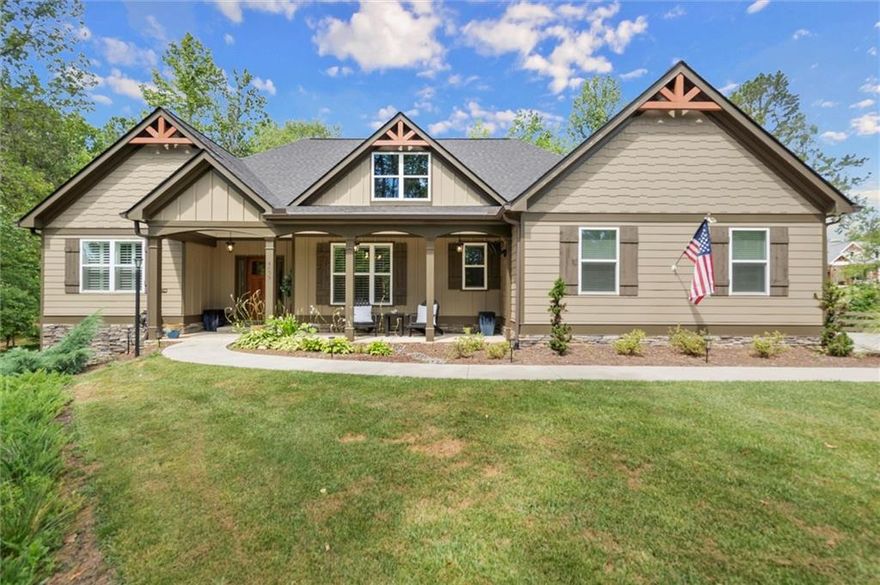 Look no further—this beautifully maintained ranch offers the best of main-level living with a bonus...full, partially finished terrace level, all nestled on a serene 2.47-acre, level lot in sought-after Ball Ground, GA. With no HOA, room to spread out, and endless possibilities, this property is a true gem! Step inside to find a gorgeous kitchen featuring top of the line stainless appliances, gas range, double ovens and a massive island that overlooks the spacious, fireside family room with coffered ceiling—ideal for everyday living or entertaining guests. Just off the main living area, an expansive covered rear deck offers the perfect place to relax, dine outdoors, or take in the peaceful views of your private wooded oasis. The backyard is loaded with lifestyle features, including a fire pit, gazebo with lighting and electrical outlets, and an additional barn/workshop—perfect for hobbyists, storage, or future projects. Downstairs, the terrace level offers a generous family/media room, bedroom and full bath, and a bright flex room—ideal as an office, craft room, or even a 5th bedroom with the addition of a closet. A large unfinished area offers space for a workshop, gym, or storage and opens to the lower-level patio and yard through a separate exterior entrance. The terrace level also has its own driveway and private entry, making it perfect for guests, multigenerational living, or rental potential—plus space to park two additional vehicles. Located just a few miles from charming Downtown Ball Ground and all it has to offer...shopping and dining and easy access to top-rated Cherokee County schools, this peaceful and versatile property is the perfect blend of rural tranquility and convenience.