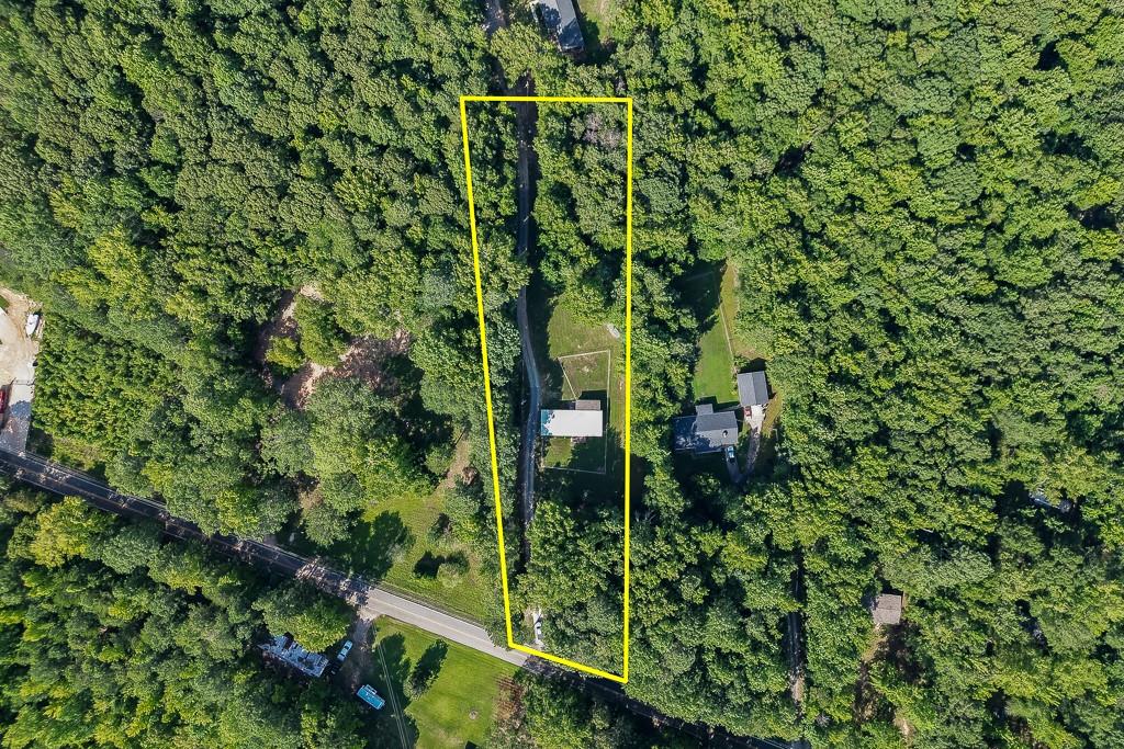 Own your own piece of privacy right in Buford! Just minutes from highway access and the Buford corn maze this usable piece of property can be your own slice of heaven. Located in Hall County, with traditionally lower property taxes this long rectangular property has approximately 91 ft of road frontage at it's widest in the back is 140 ft. (buyer to verify.) Utilities are located on the property.
Sold with property is a 1972 double wide in great condition. All appliances stay with the home. Roof was recently replaced, some plumbing has been updated. Home is in good condition, you may choose to update. Home offers galley kitchen, large open living room with ample daylight and a LARGE screened in porch! The yard is also already fenced for your favorite fur babies.
This property offers privacy and comfort close to shopping, restaurants etc. Whether you choose to live in the home or build your own this can be HOME.
Property line goes roughly back to old cement lids for abandoned wells. Please do not bother back owner. Home does not qualify for FHA to VA, I'm sorry.