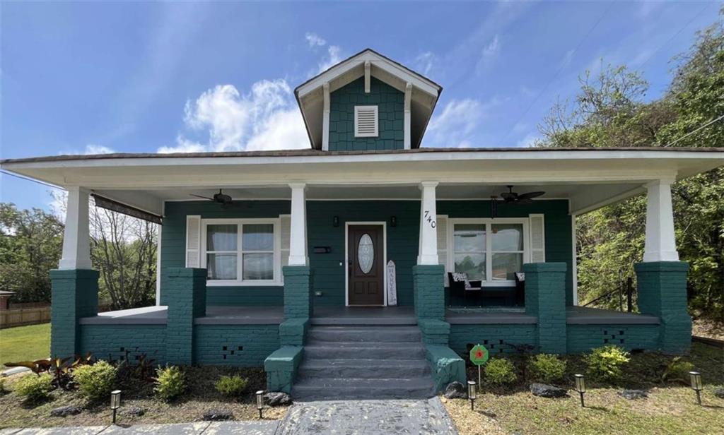 Beautifully restored bungalow style home that seamlessly blends historic charm with modern amenities in the vibrant Beall's Hill neighborhood. The property boasts a spacious covered front porch and deck, ideal for Southern entertaining. Inside, you'll find real hardwood floors, recessed lighting, and electric fireplaces. The master suite offers a double-tray ceiling, en-suite bathroom with soaking tub and walk-in shower. The modern kitchen is equipped with soft-close wood cabinets, stainless steel appliances, an island/bar, and quartz countertops. Additional features include central heating and air conditioning, open floor concept, and in-unit laundry. Located within walking distance to Mercer University, historic downtown Macon, Tattnall Square Park, and local hospitals.