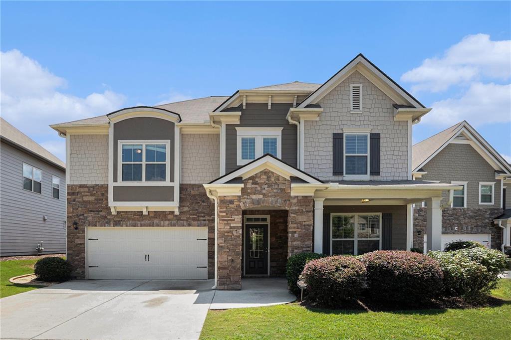 Welcome back to this beautifully updated 5-bedroom, 3-bath home in the desirable Bogan Meadows community! Enjoy a charming covered front porch and level driveway leading to a two-car garage. Inside, the open-concept layout is ideal for both everyday living and entertaining. The formal dining room flows seamlessly into a chef-inspired kitchen featuring a large island, white cabinetry, stone countertops, and stainless steel appliances—all overlooking the warm and inviting family room. A guest bedroom and full bath on the main level provide flexibility for visitors or a home office. Upstairs, you'll find four spacious bedrooms, including a generous owner’s suite with a private sitting area perfect for relaxing or working from home. The spa-style primary bath offers dual vanities, a soaking tub, and a separate shower. A convenient upstairs laundry room and ample storage complete the second level. Step outside to a private, fenced backyard with plenty of space for outdoor living and play. This move-in ready home blends style, comfort, and function in a sought-after neighborhood—schedule your showing today!